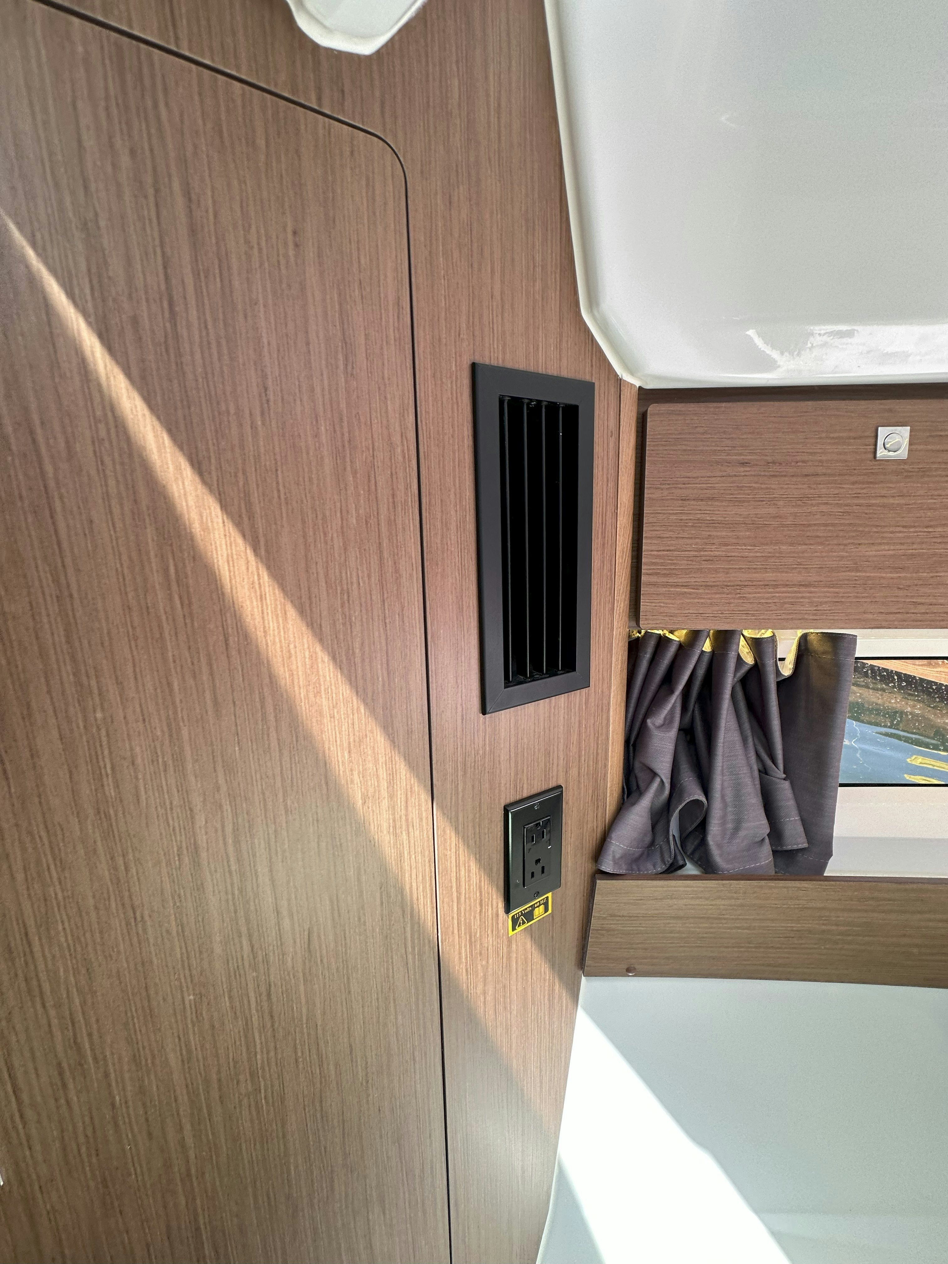 a wood wall with a vent aboard DESTINATION UNKNOWN II Yacht for Sale