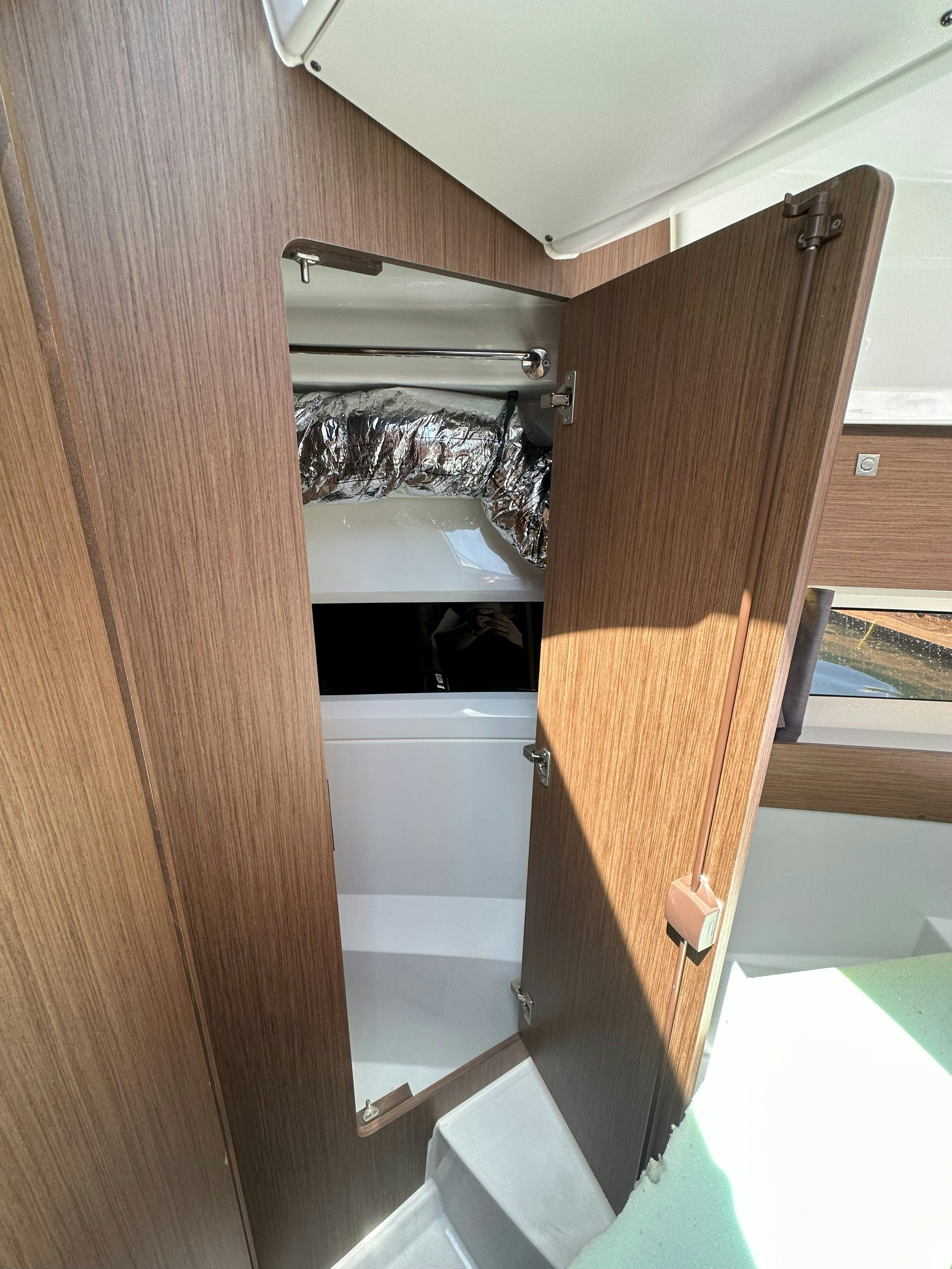 a bathroom with a wood door aboard DESTINATION UNKNOWN II Yacht for Sale