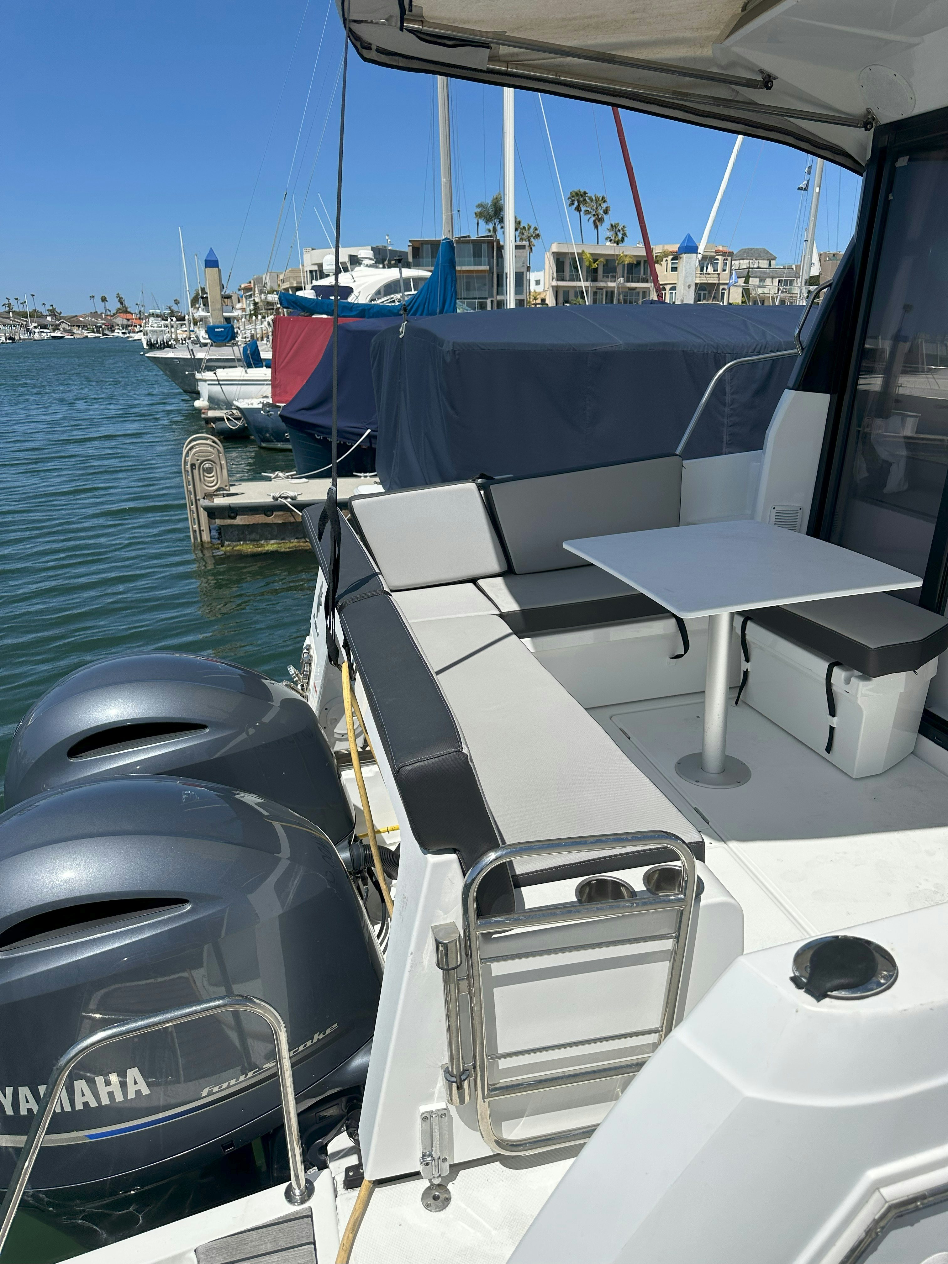 a boat with a table and chairs aboard DESTINATION UNKNOWN II Yacht for Sale
