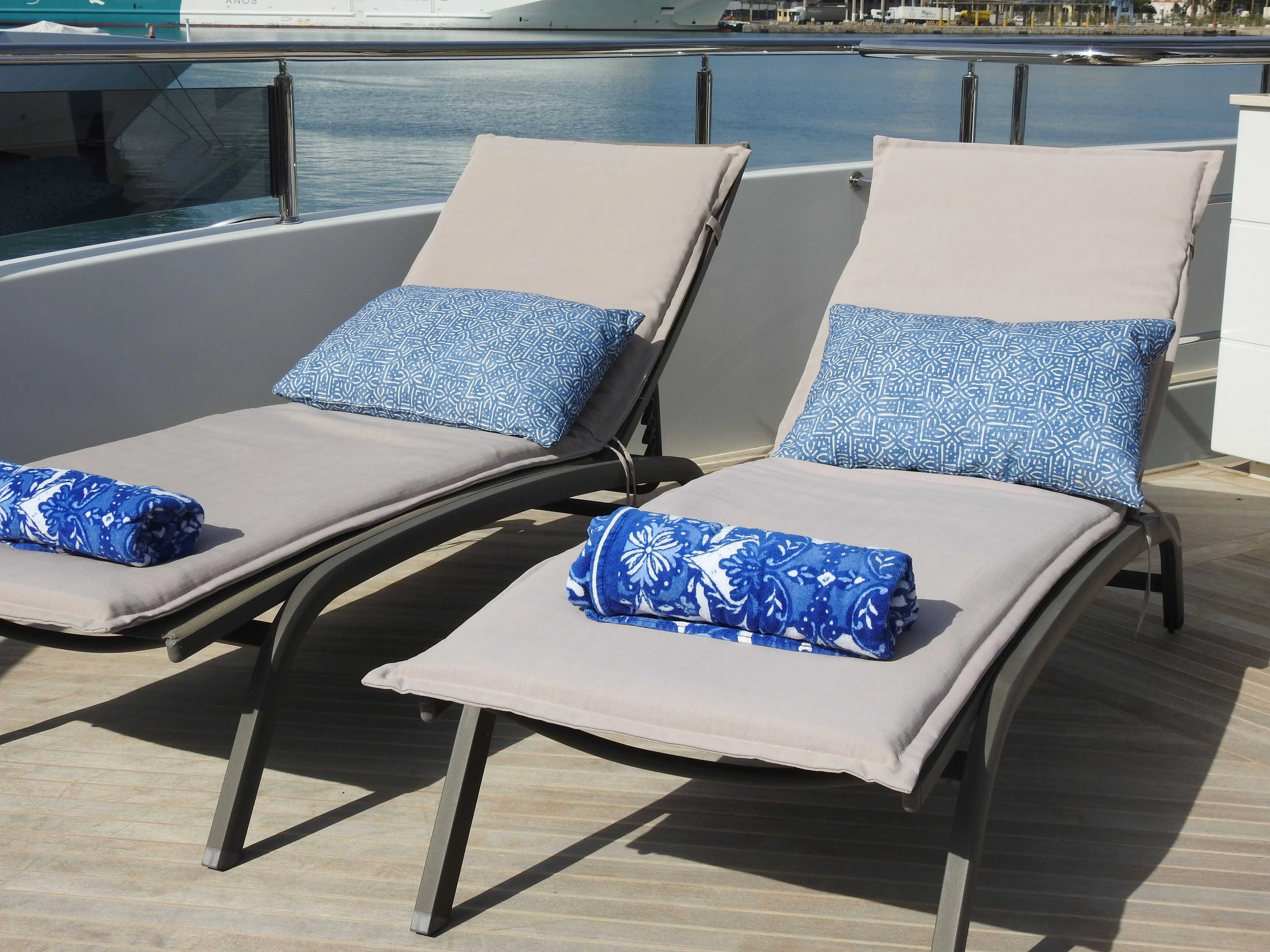 a couple of couches on a deck by a pool aboard SHU U RITE Yacht for Sale