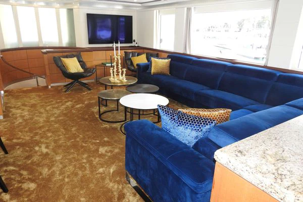 a living room with a blue couch aboard SHU U RITE Yacht for Sale