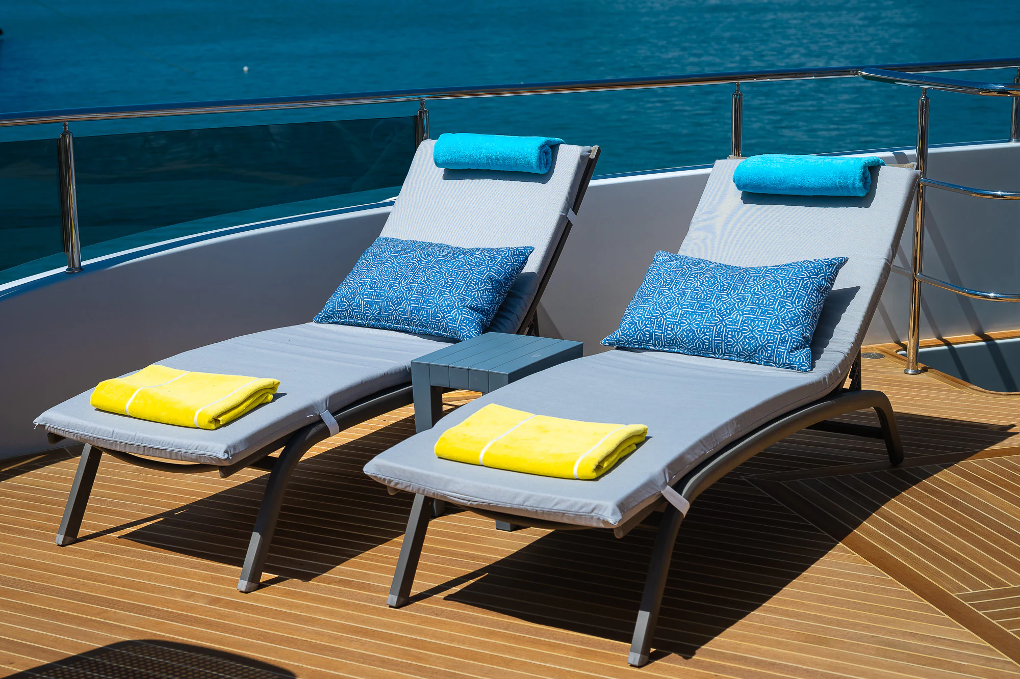 a couple of lounge chairs on a deck overlooking the ocean aboard SHU U RITE Yacht for Sale