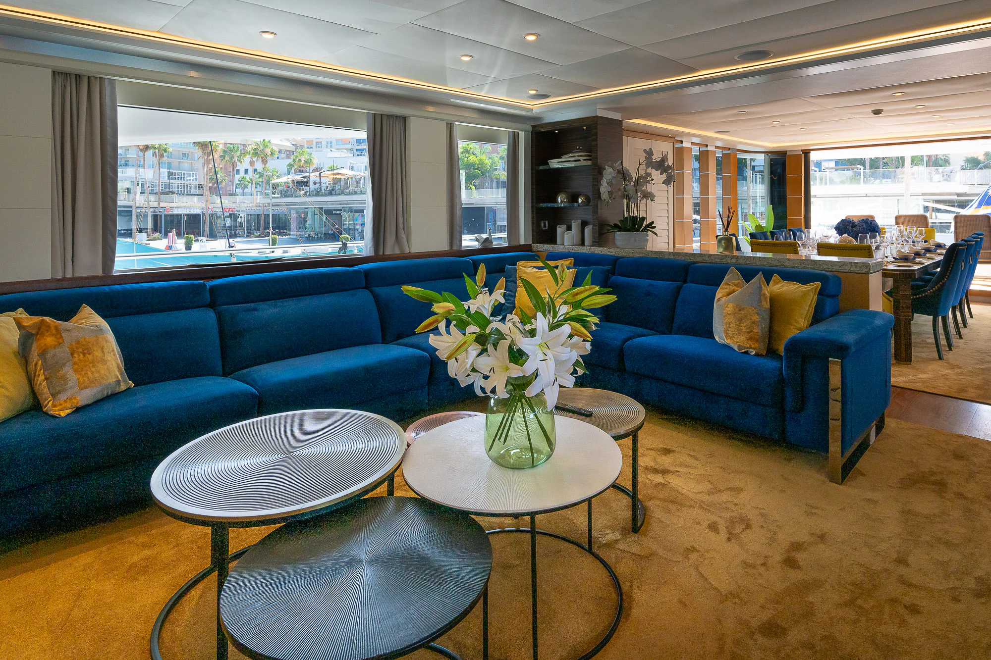 a living room with a blue couch and a coffee table aboard SHU U RITE Yacht for Sale