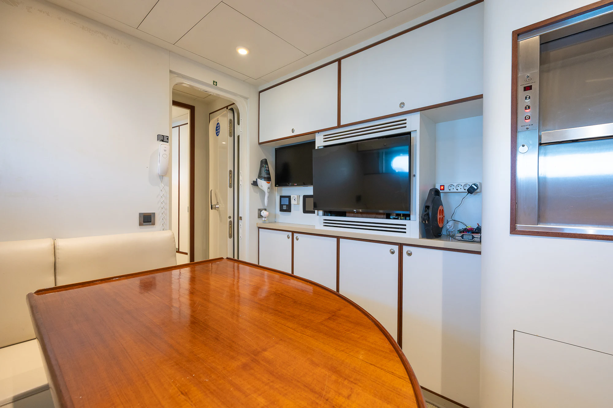 a kitchen with a table and a tv aboard SHU U RITE Yacht for Sale