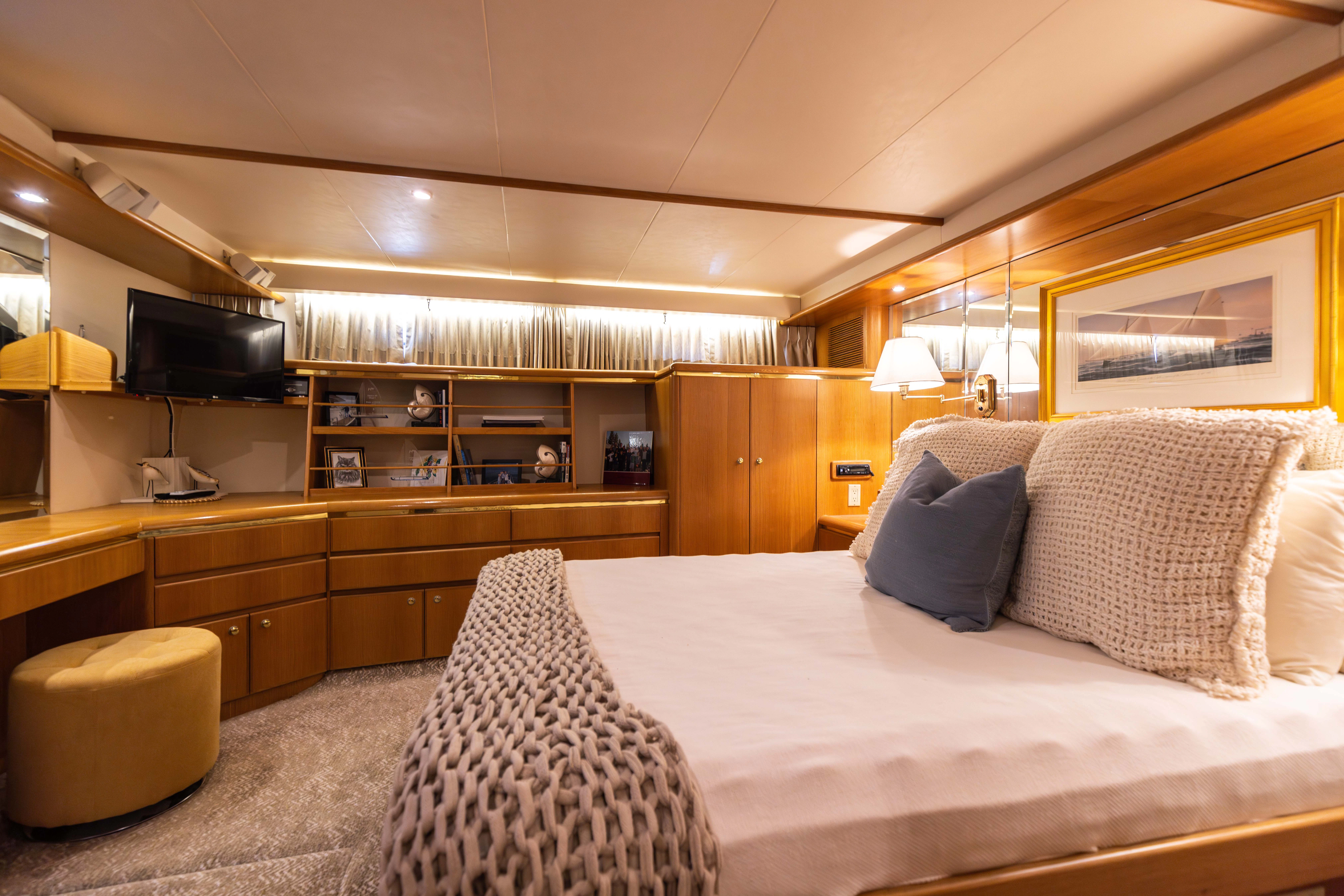 a large bed in a room aboard 3TEN Yacht for Sale