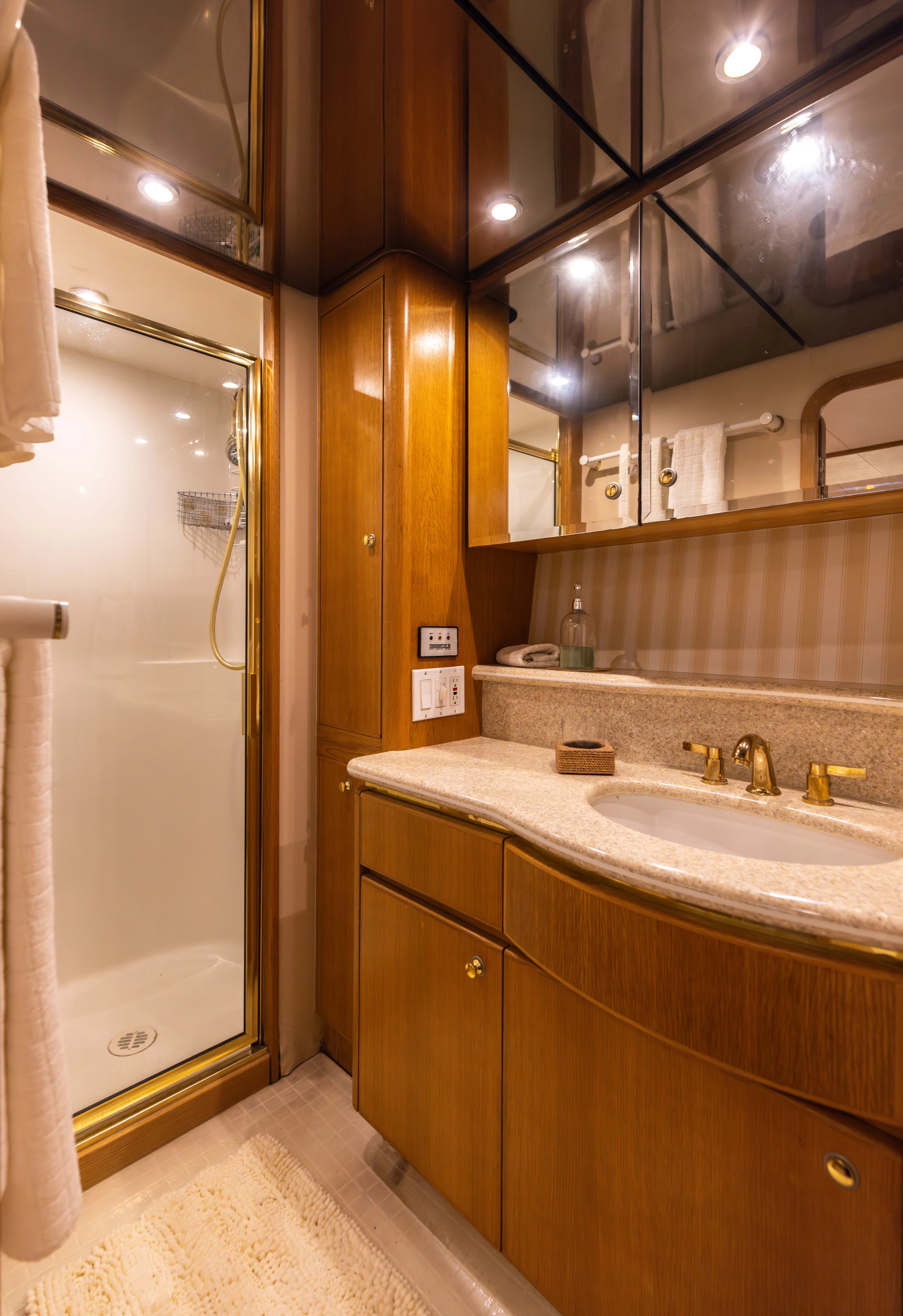 a bathroom with a sink and a mirror aboard 3TEN Yacht for Sale