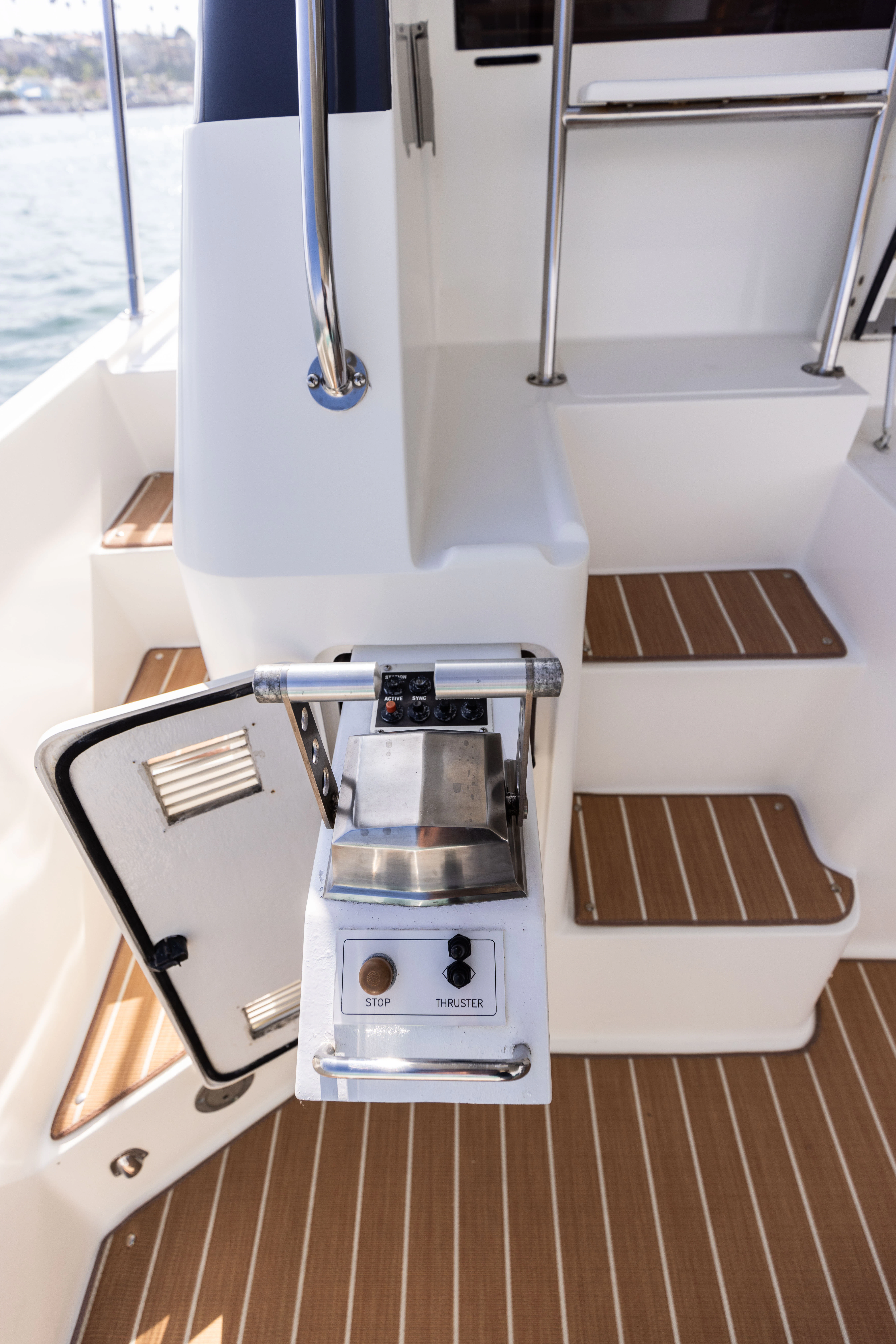 a white kitchen with a large white stove and a wood floor aboard 3TEN Yacht for Sale