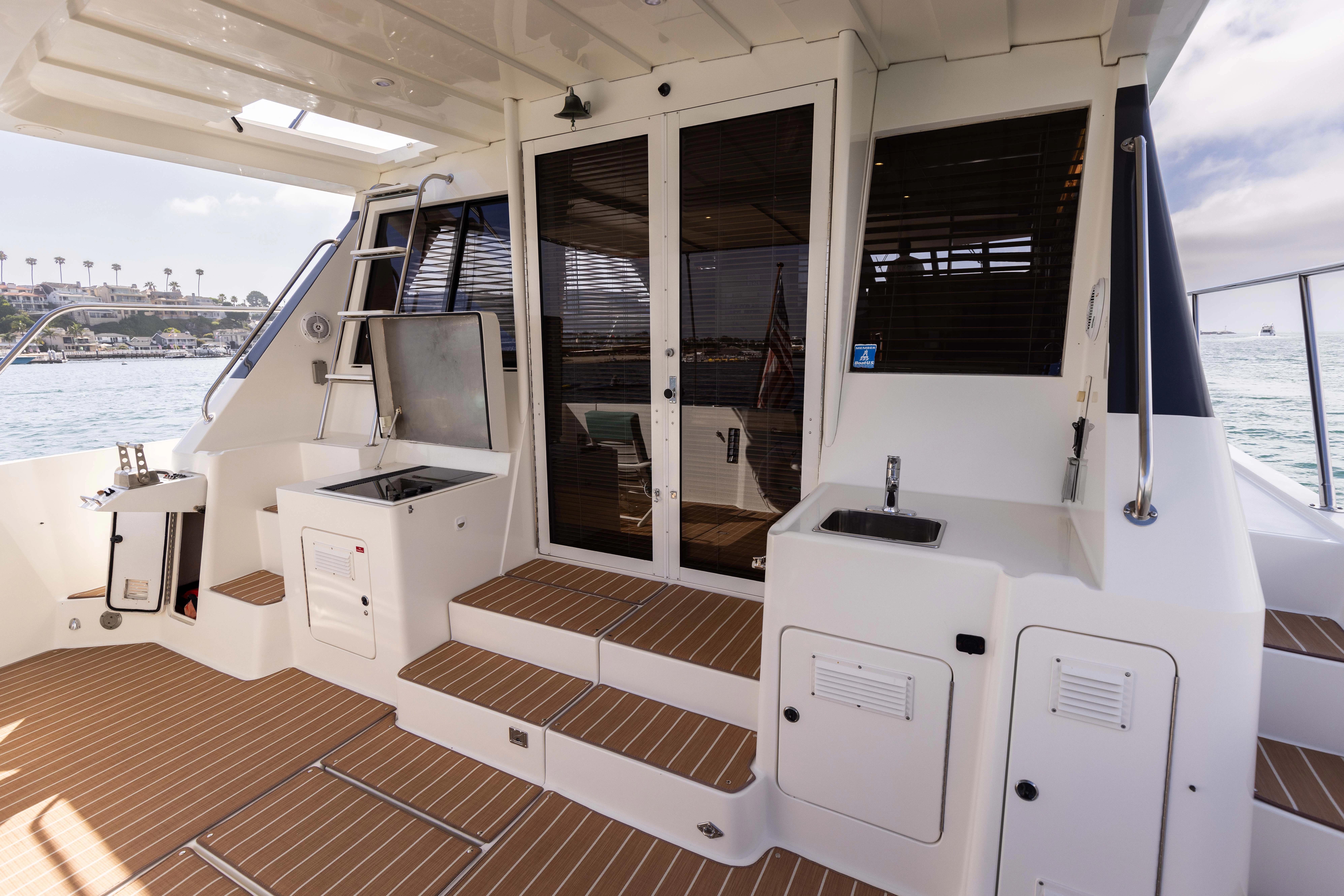 a boat with open doors aboard 3TEN Yacht for Sale