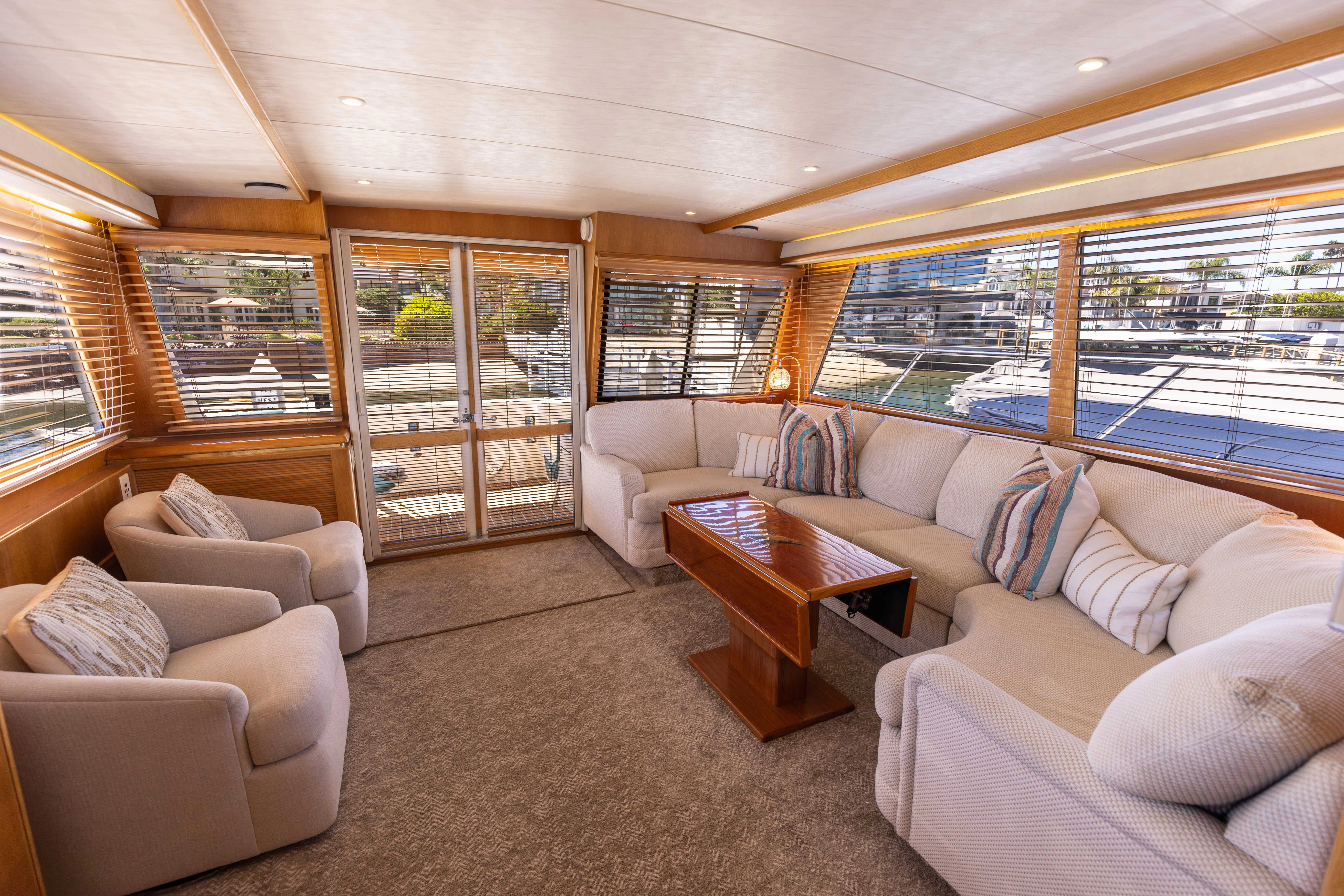 a living room with a large window aboard 3TEN Yacht for Sale