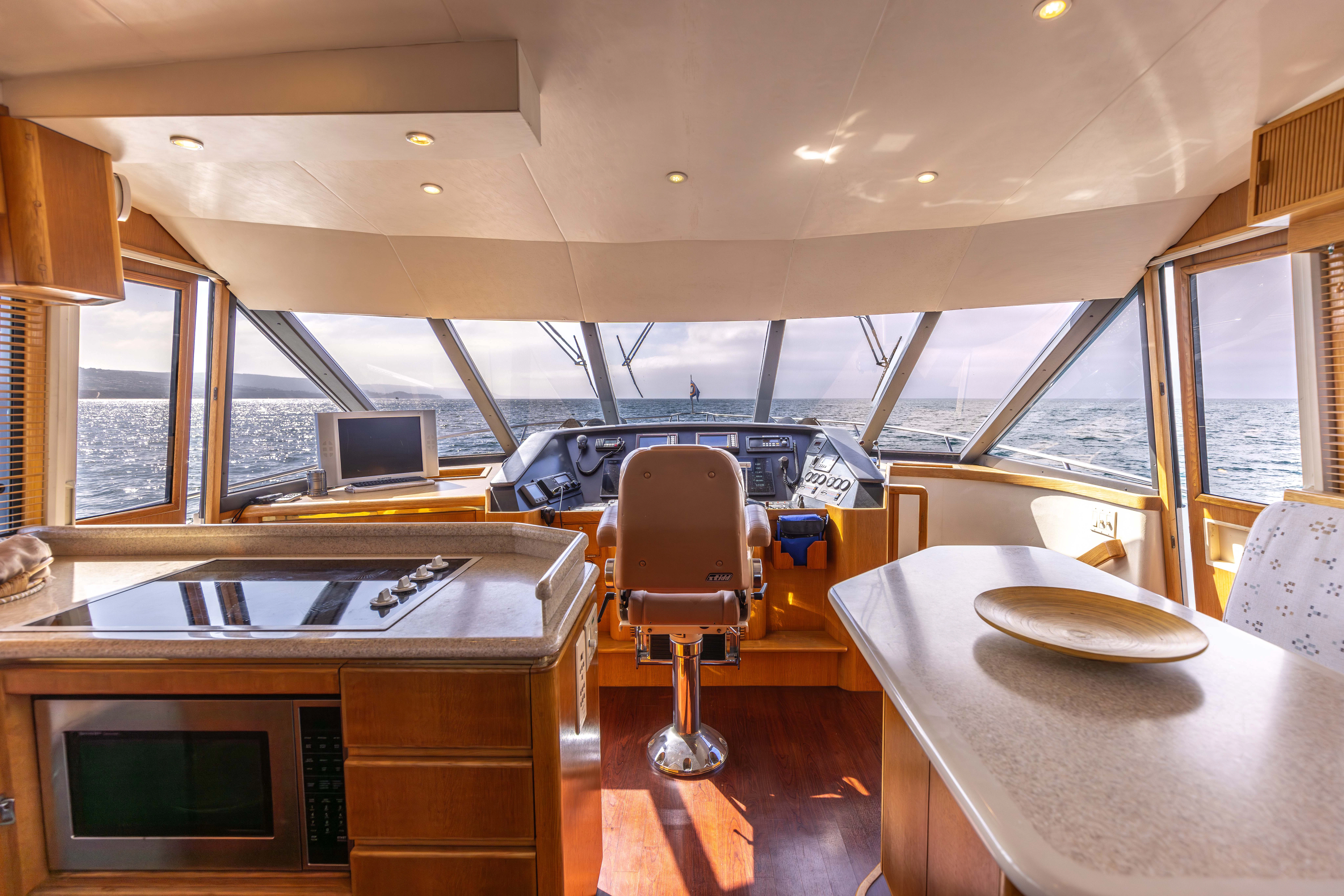 a room with a table and chairs aboard 3TEN Yacht for Sale
