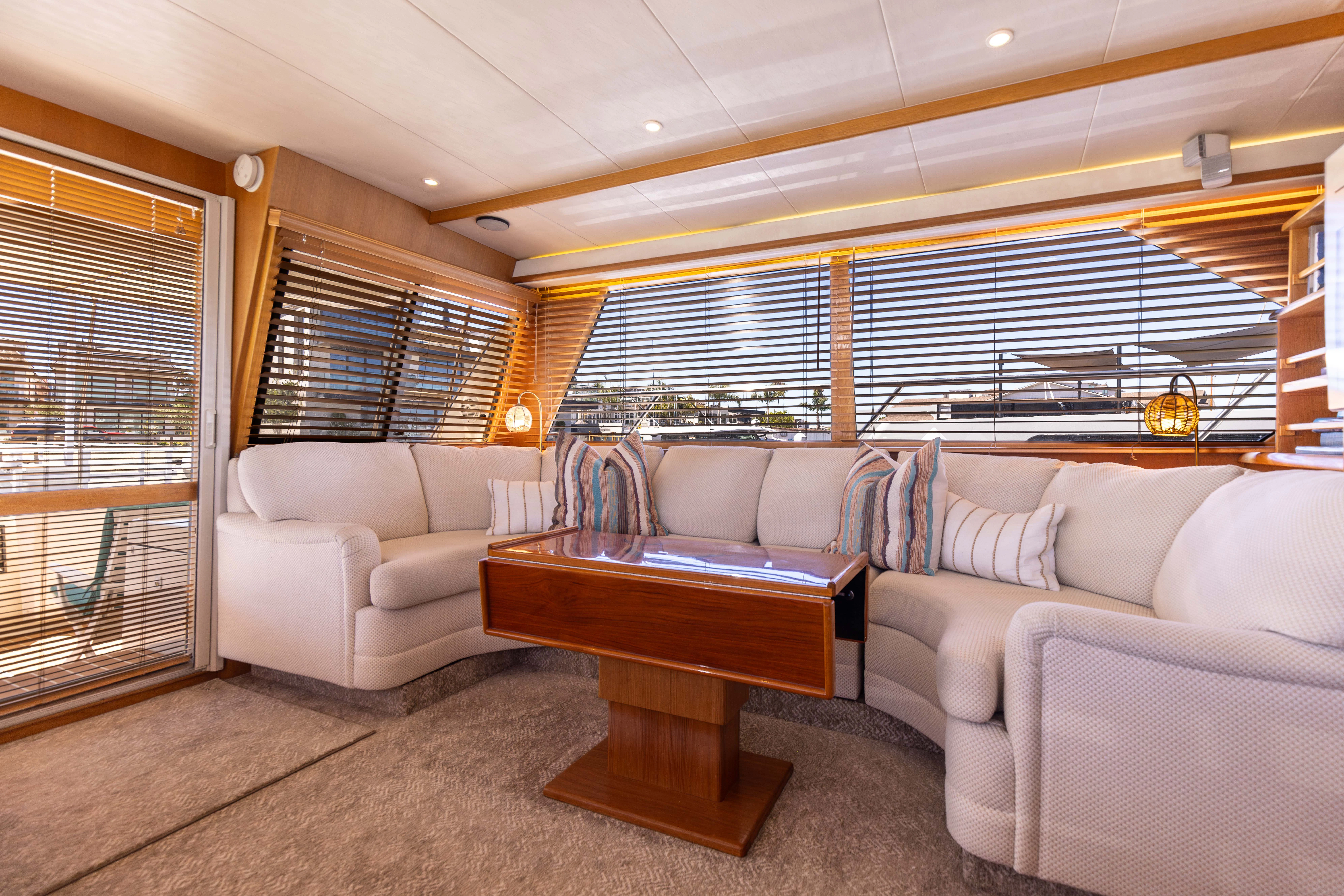 a living room with a large window aboard 3TEN Yacht for Sale