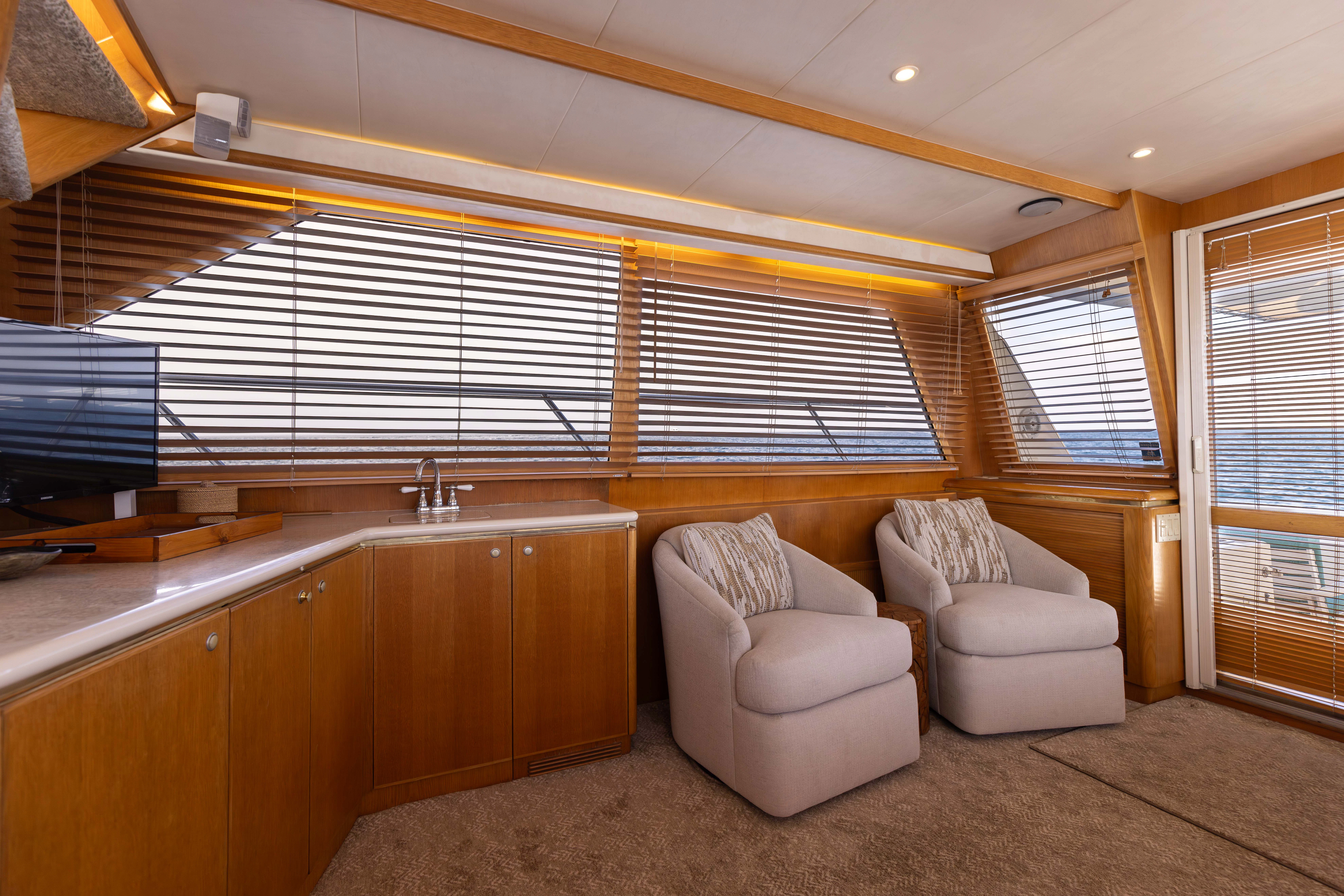 a room with a couch and a television aboard 3TEN Yacht for Sale