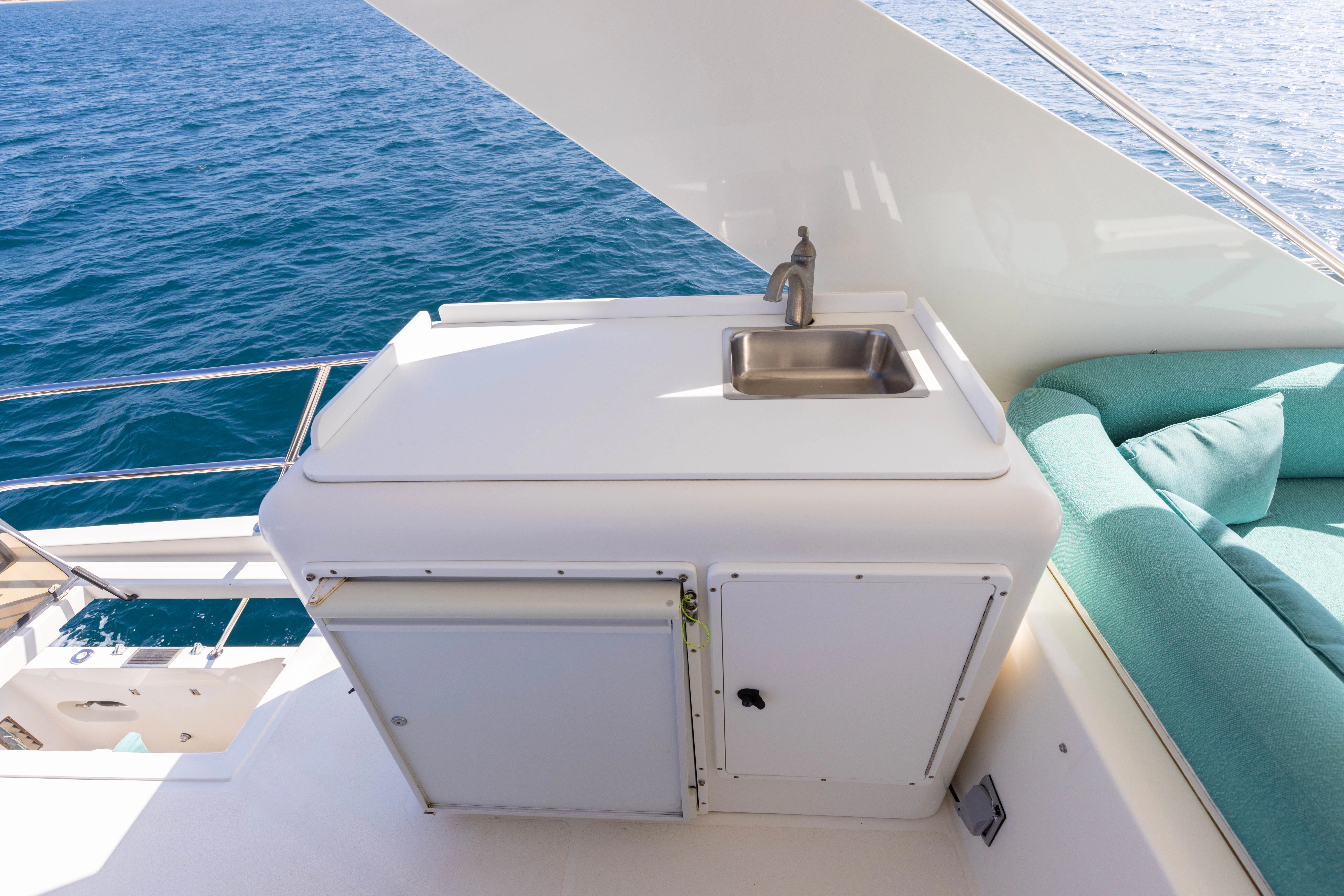 a white boat with a sink on it aboard 3TEN Yacht for Sale