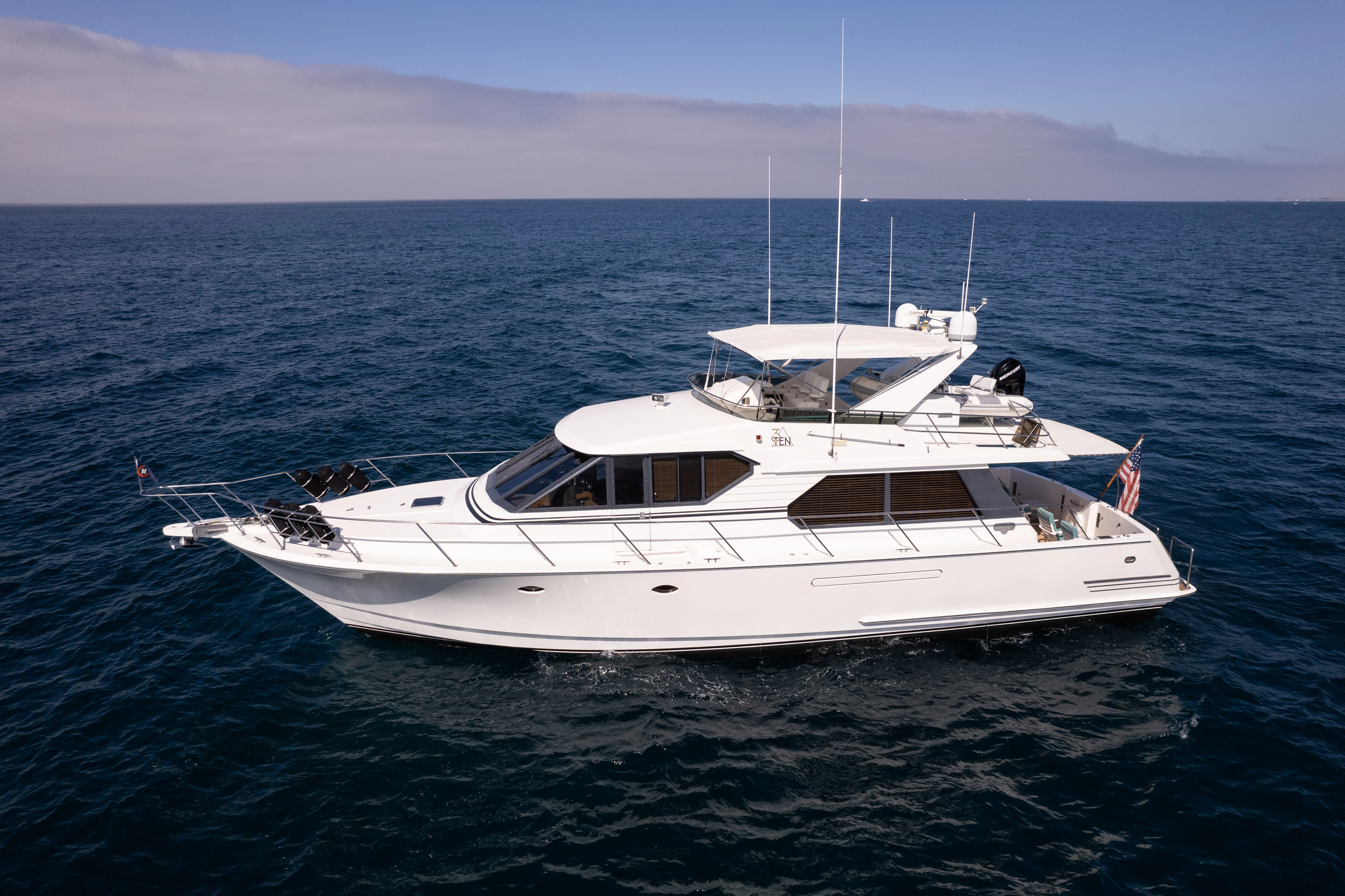 a white yacht in the water aboard 3TEN Yacht for Sale