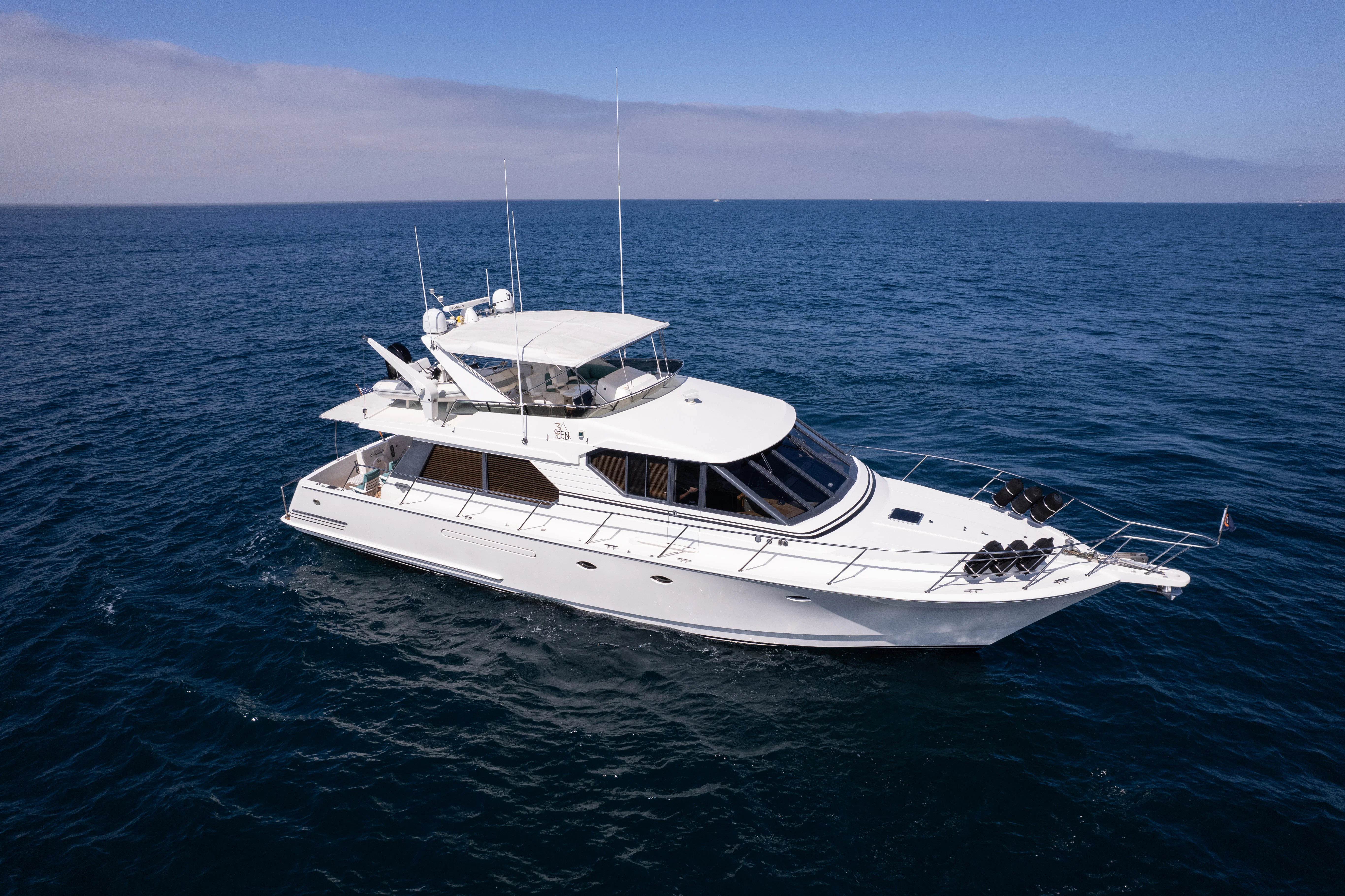 a white yacht in the water aboard 3TEN Yacht for Sale