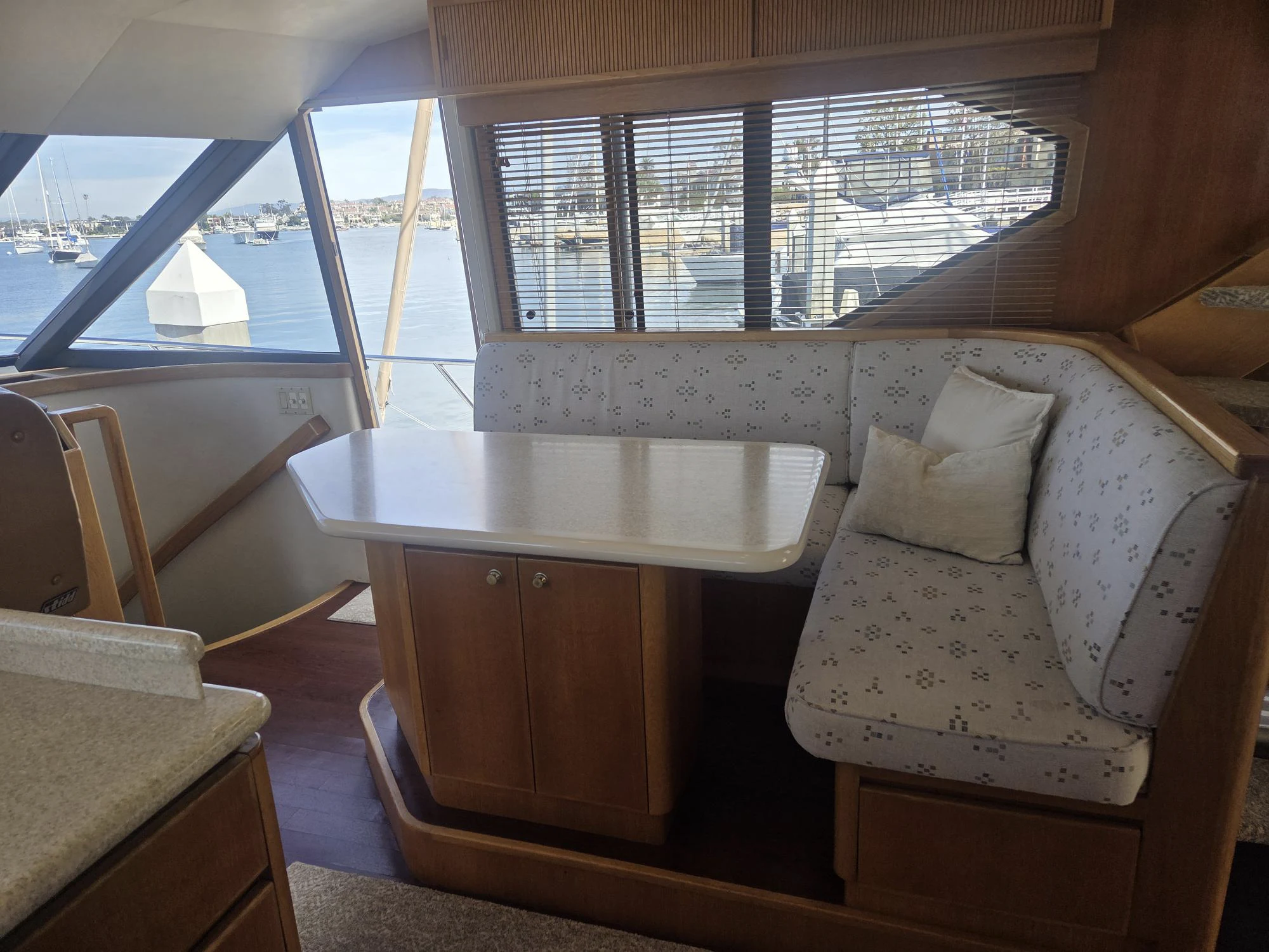 a room with a table and couch aboard 3TEN Yacht for Sale