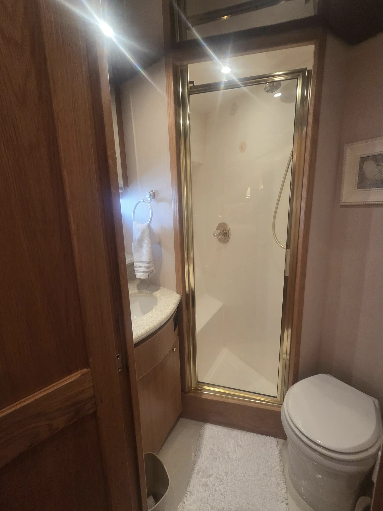 a bathroom with a large mirror aboard 3TEN Yacht for Sale
