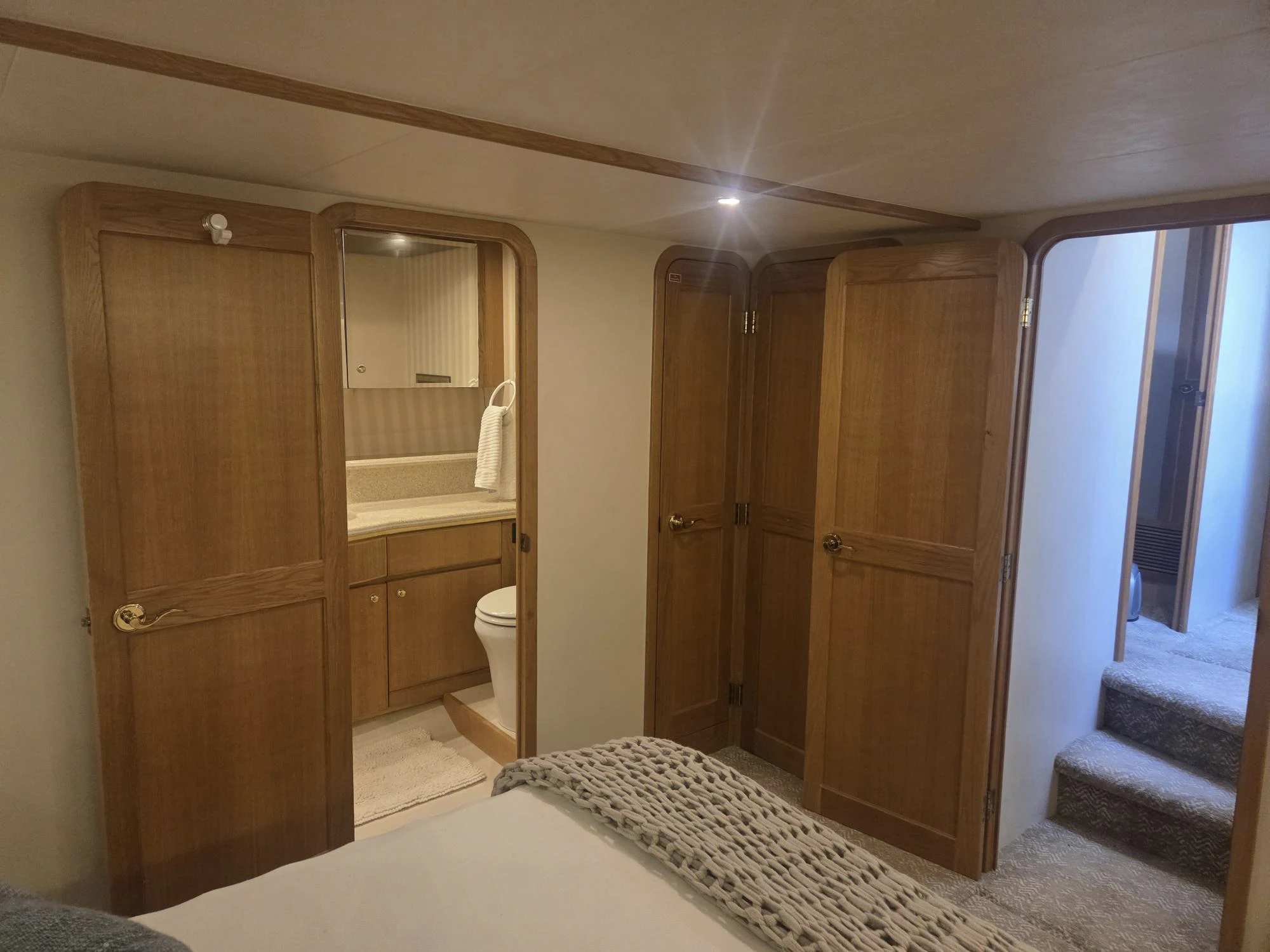 a bathroom with a large mirror aboard 3TEN Yacht for Sale