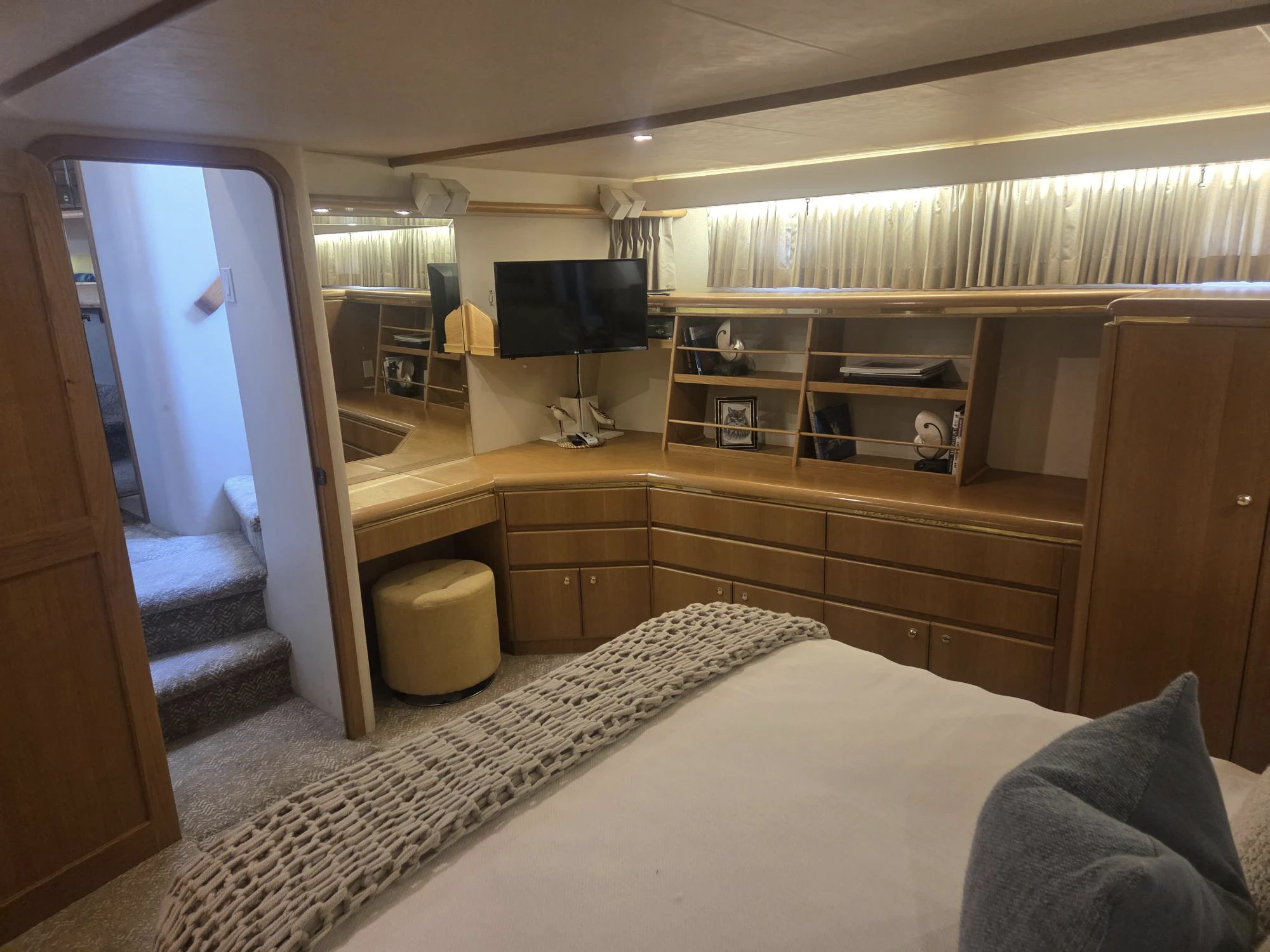 a bedroom with a bed and a tv aboard 3TEN Yacht for Sale