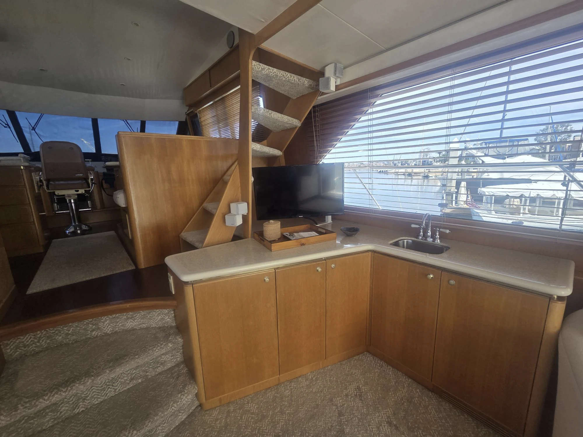 a kitchen with wooden cabinets aboard 3TEN Yacht for Sale