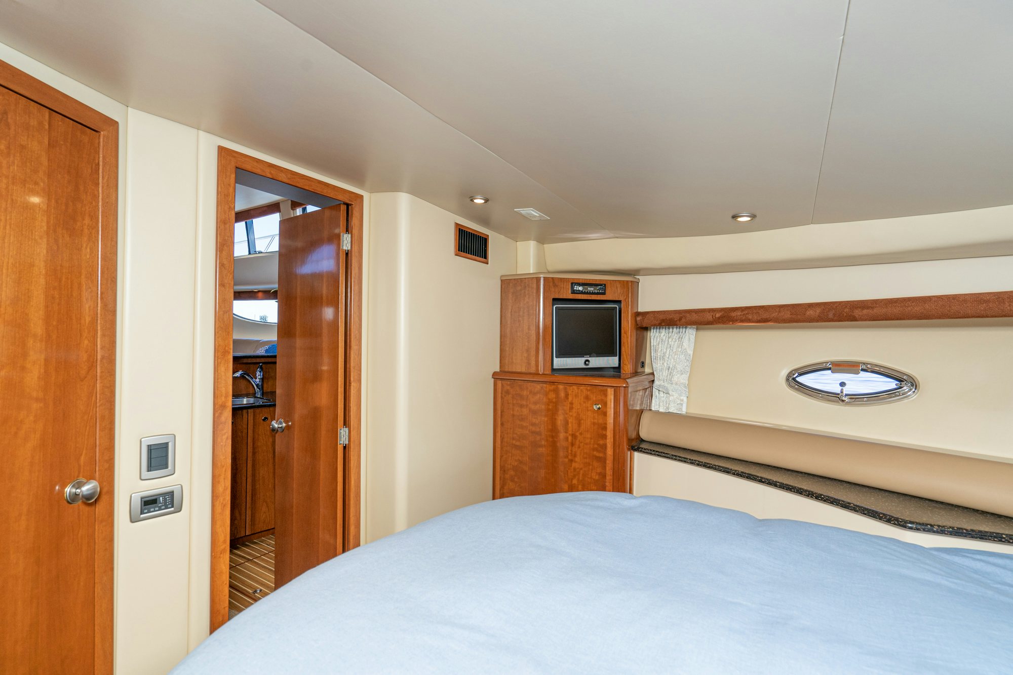 a bedroom with a bed and a television aboard THE SEA IS FOR ME Yacht for Sale