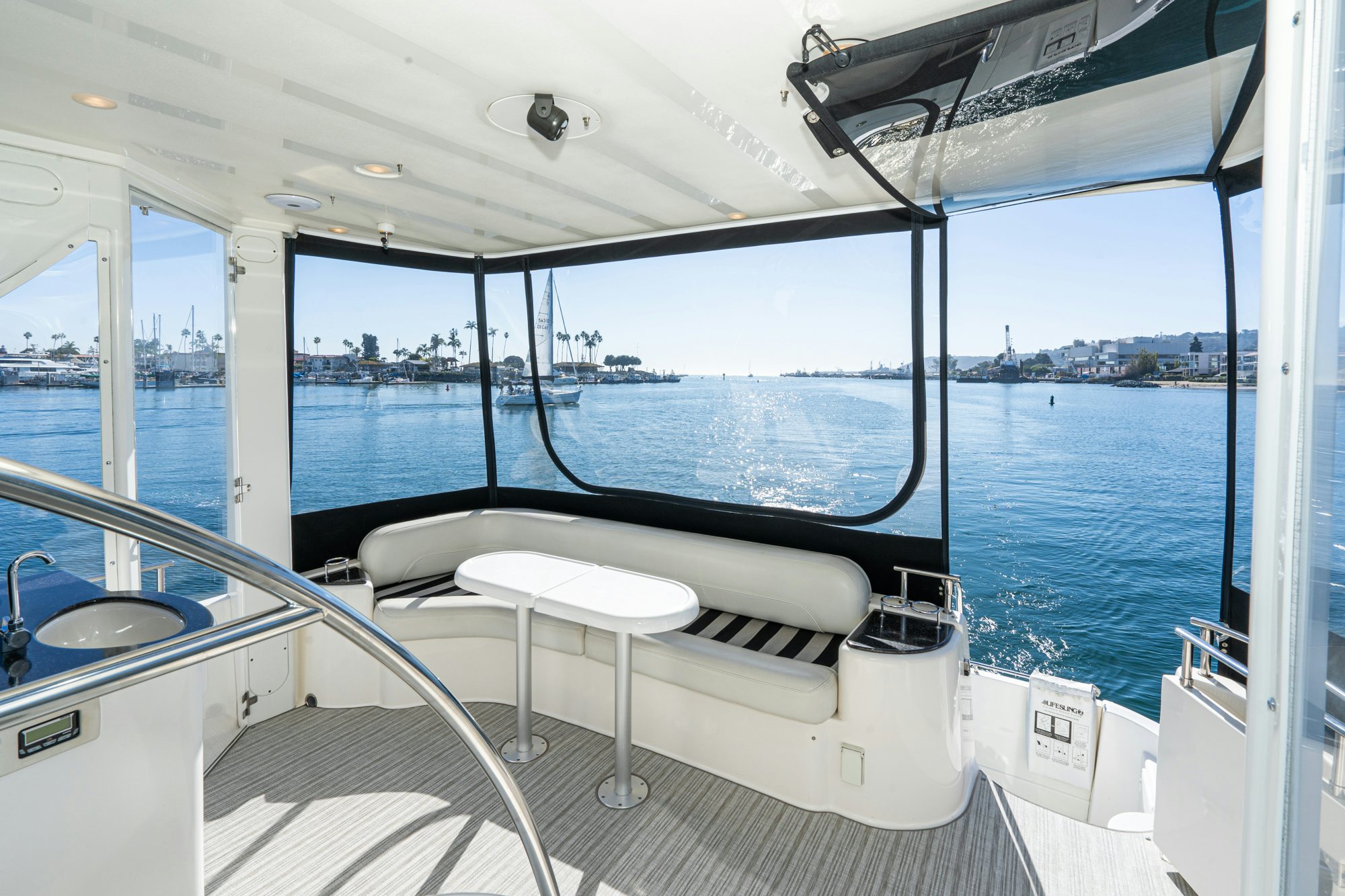 a boat with a white seat and a white table on the deck aboard THE SEA IS FOR ME Yacht for Sale