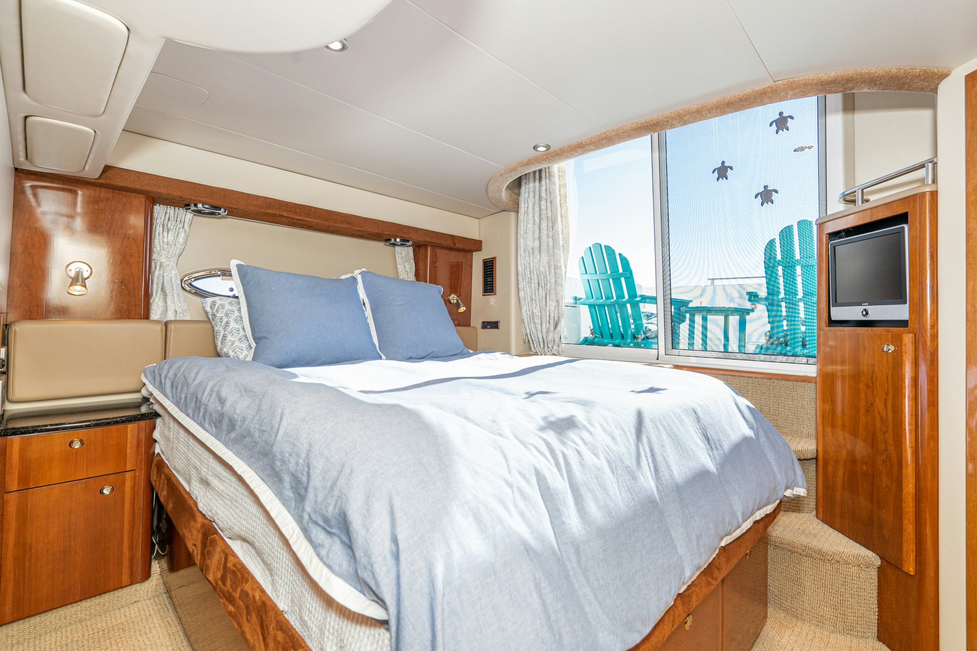 a bed with a blue pillow aboard THE SEA IS FOR ME Yacht for Sale