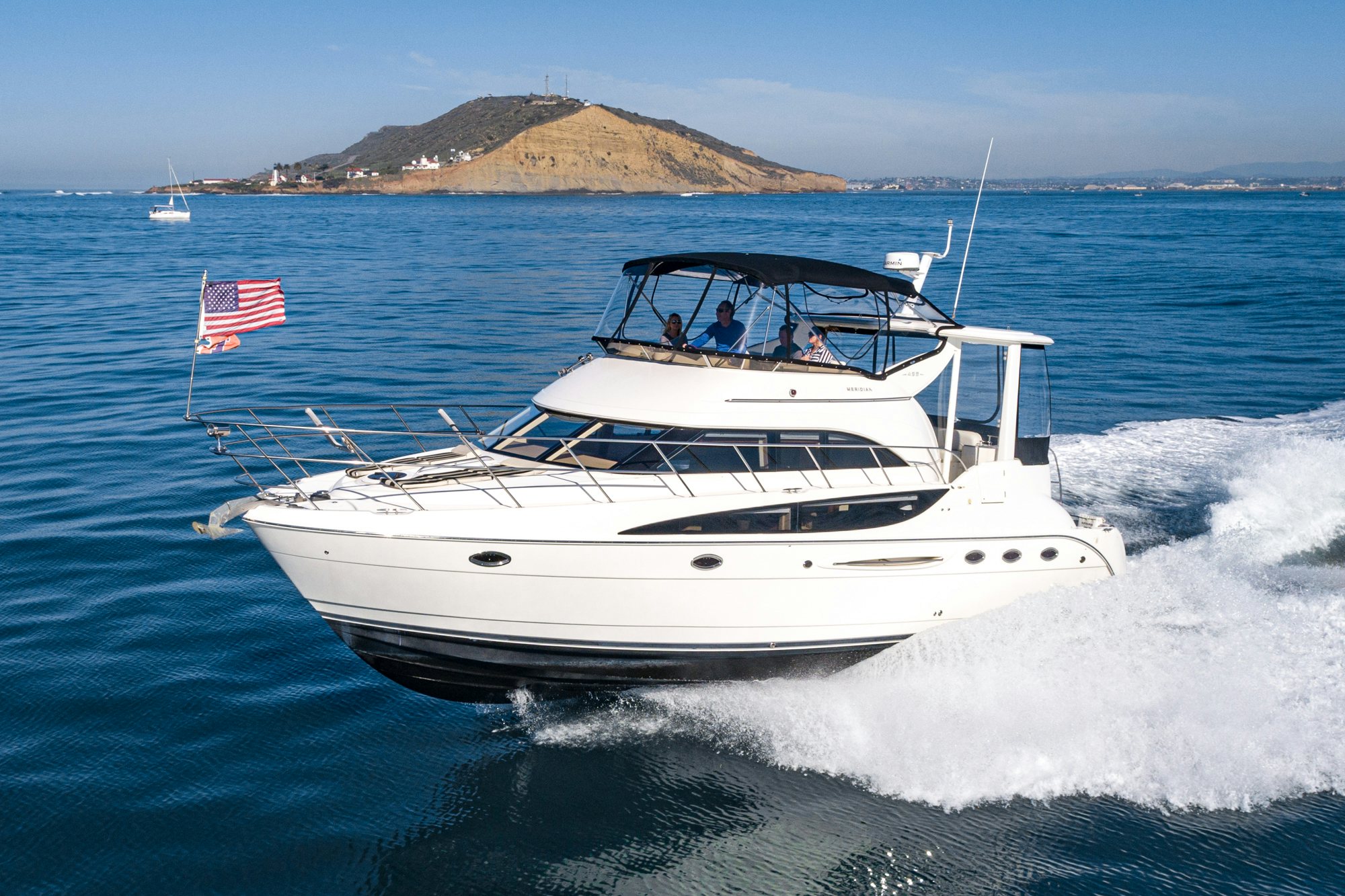 a boat with a flag on it aboard THE SEA IS FOR ME Yacht for Sale