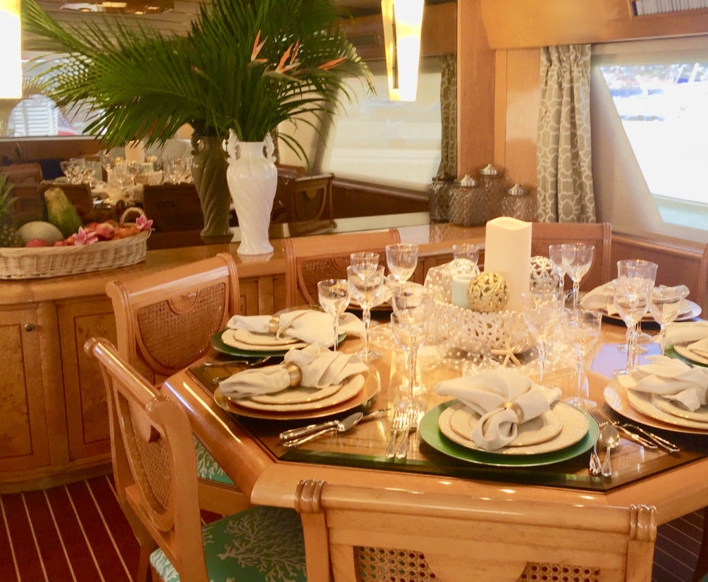 a table set with plates and glasses aboard SUITE LIFE Yacht for Sale