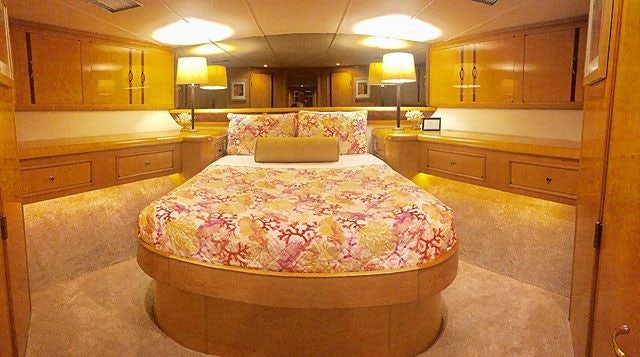 a bedroom with a bed aboard SUITE LIFE Yacht for Sale