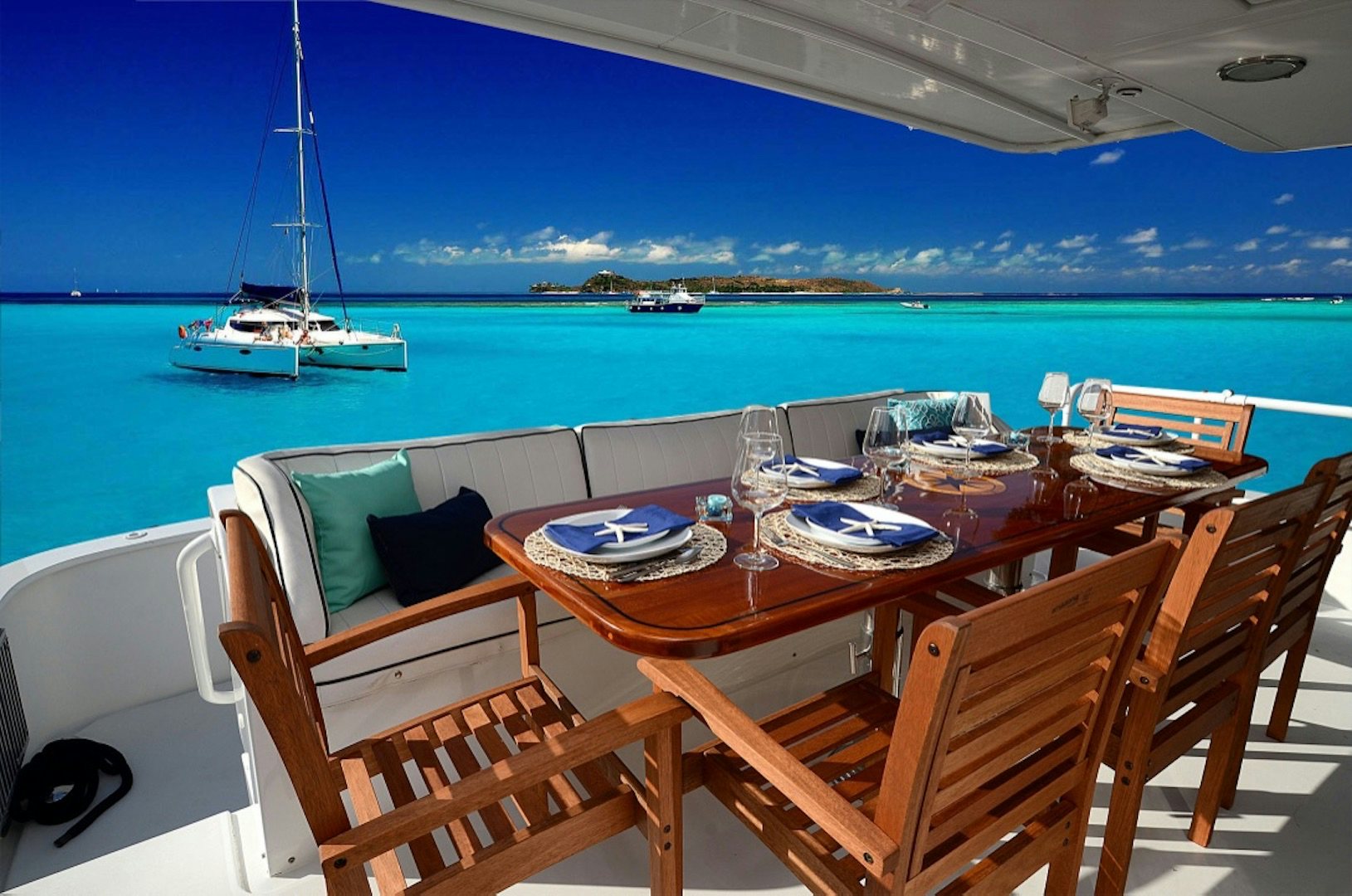 a table with chairs and a view of the ocean aboard SUITE LIFE Yacht for Sale