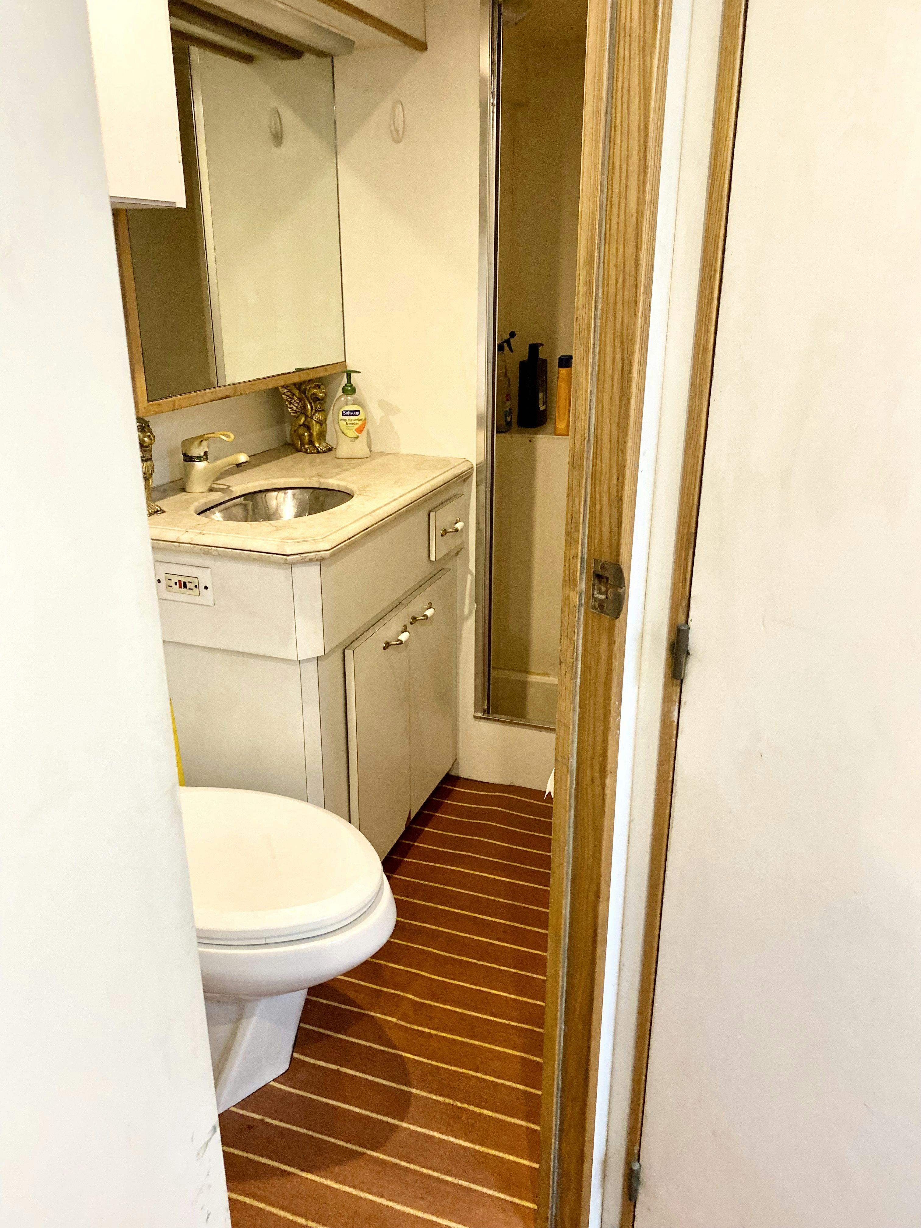 a bathroom with a sink toilet and a mirror aboard SUITE LIFE Yacht for Sale