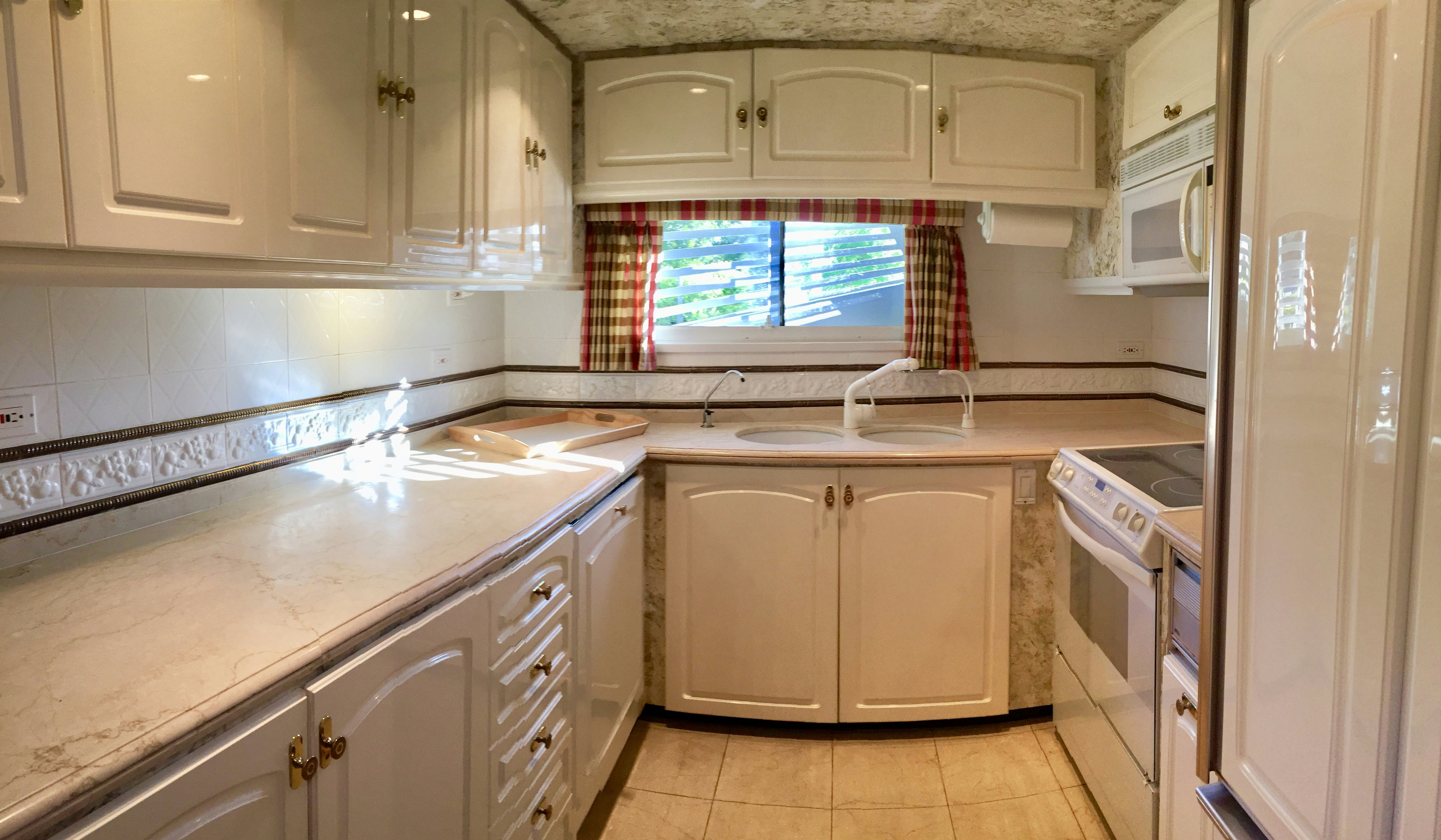 a kitchen with white cabinets aboard SUITE LIFE Yacht for Sale