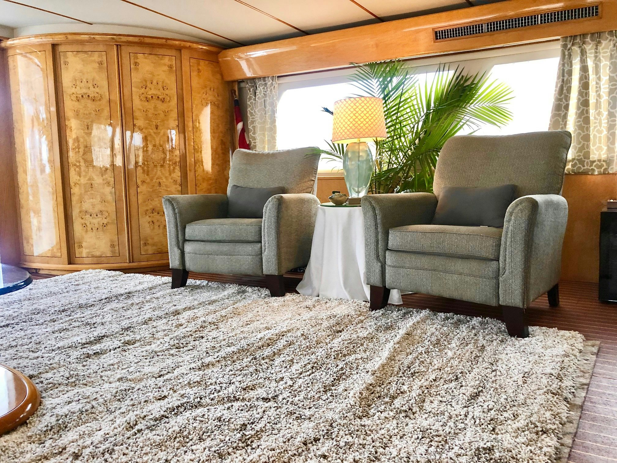 a living room with a couch and a lamp aboard SUITE LIFE Yacht for Sale