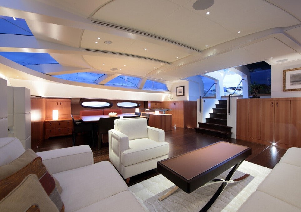 a room with a table and chairs aboard MIRASOL Yacht for Sale