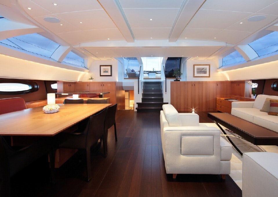 a room with a table and chairs aboard MIRASOL Yacht for Sale