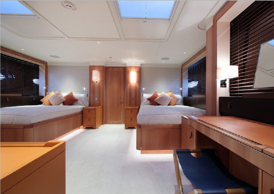 a room with a bed and a desk aboard MIRASOL Yacht for Sale