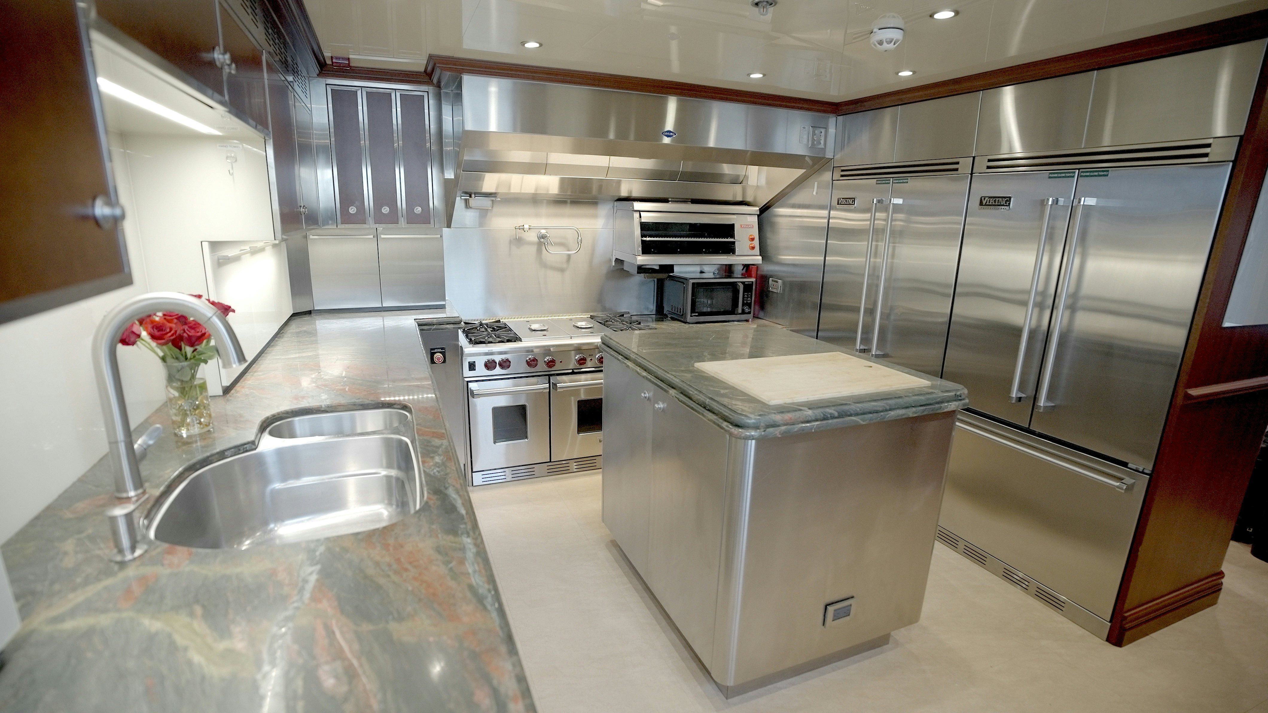 a kitchen with stainless steel appliances aboard HOMECOMING Yacht for Sale