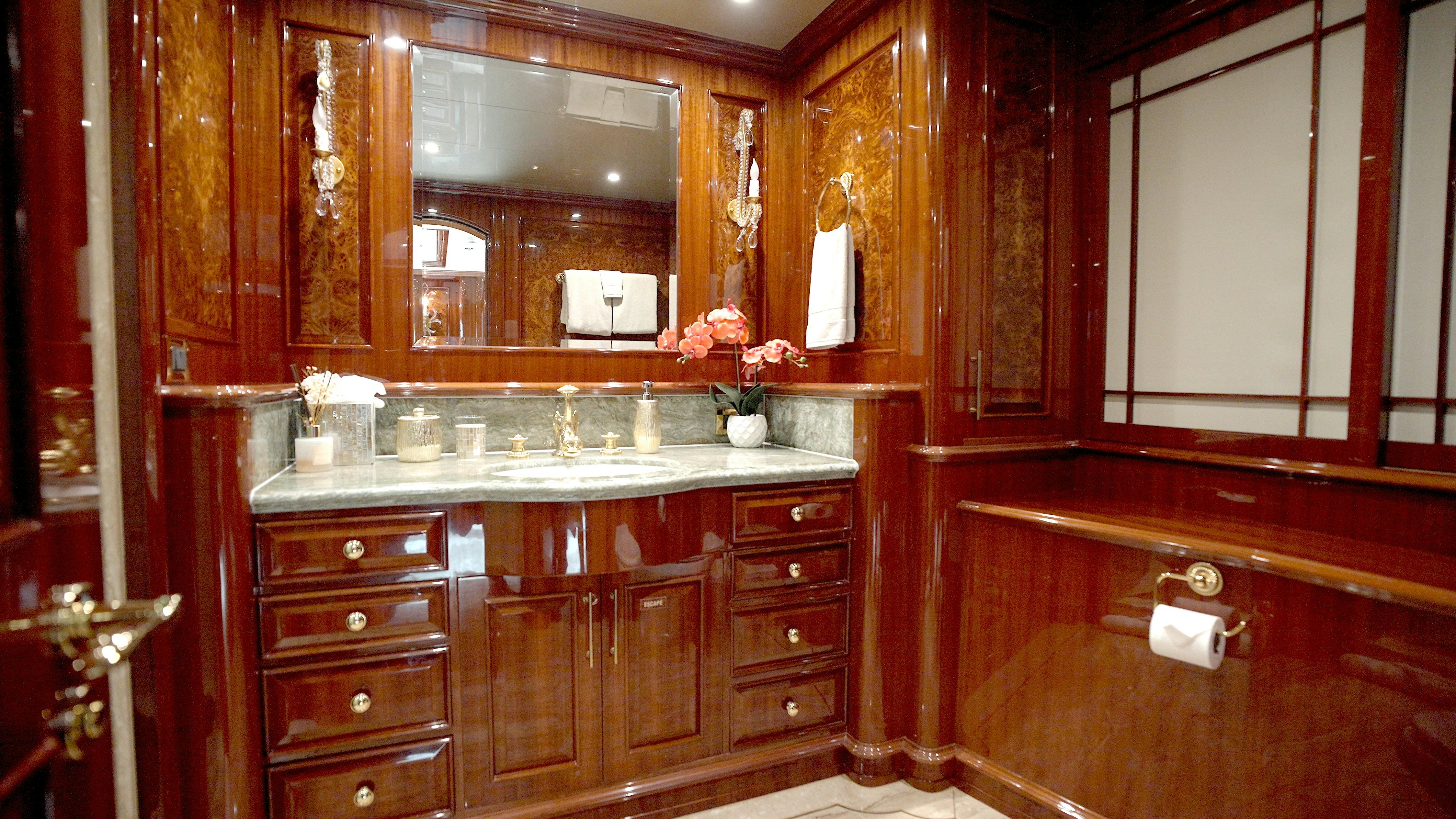 a bathroom with a large mirror aboard HOMECOMING Yacht for Sale