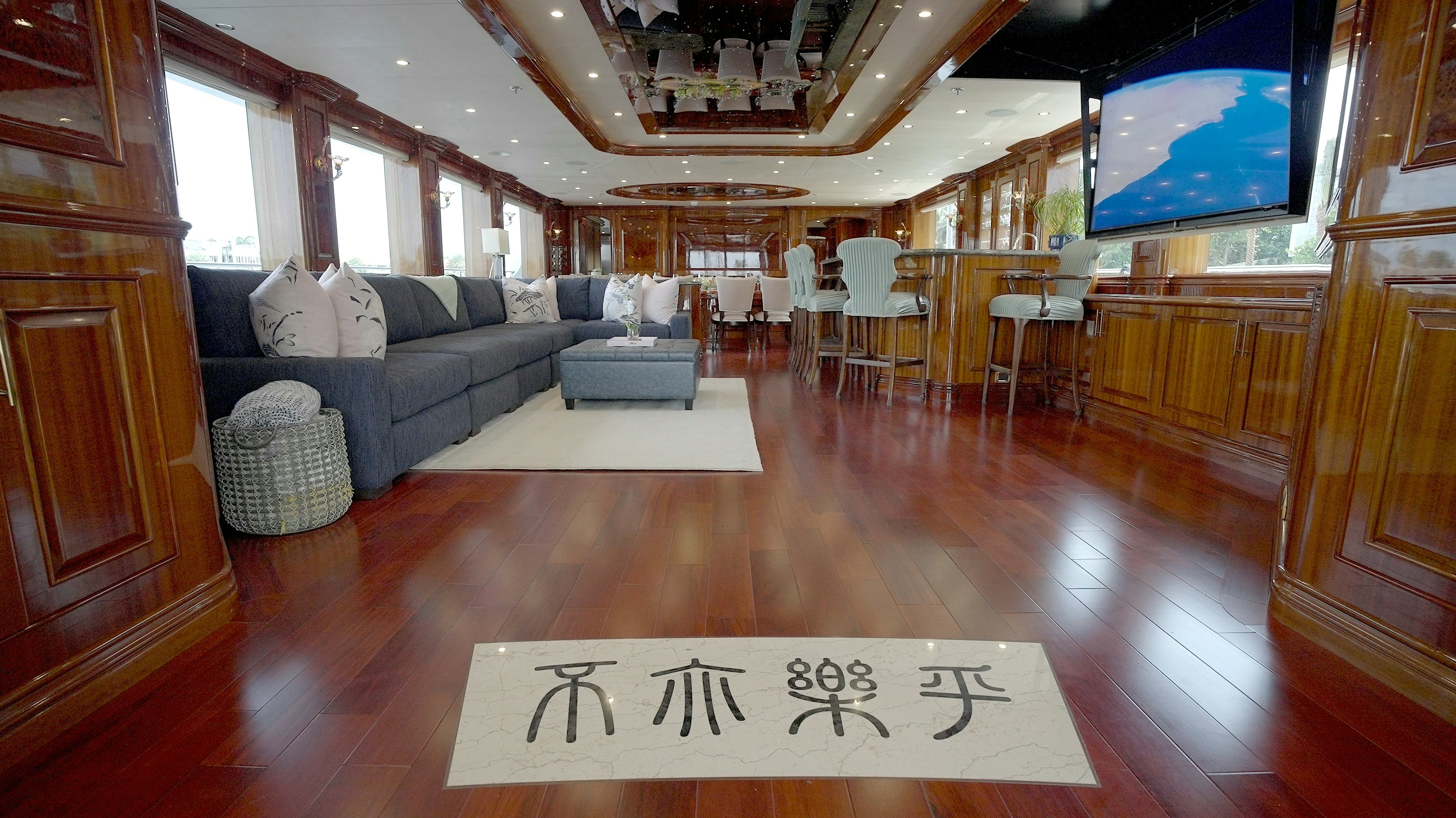 a room with a couch and chairs aboard HOMECOMING Yacht for Sale