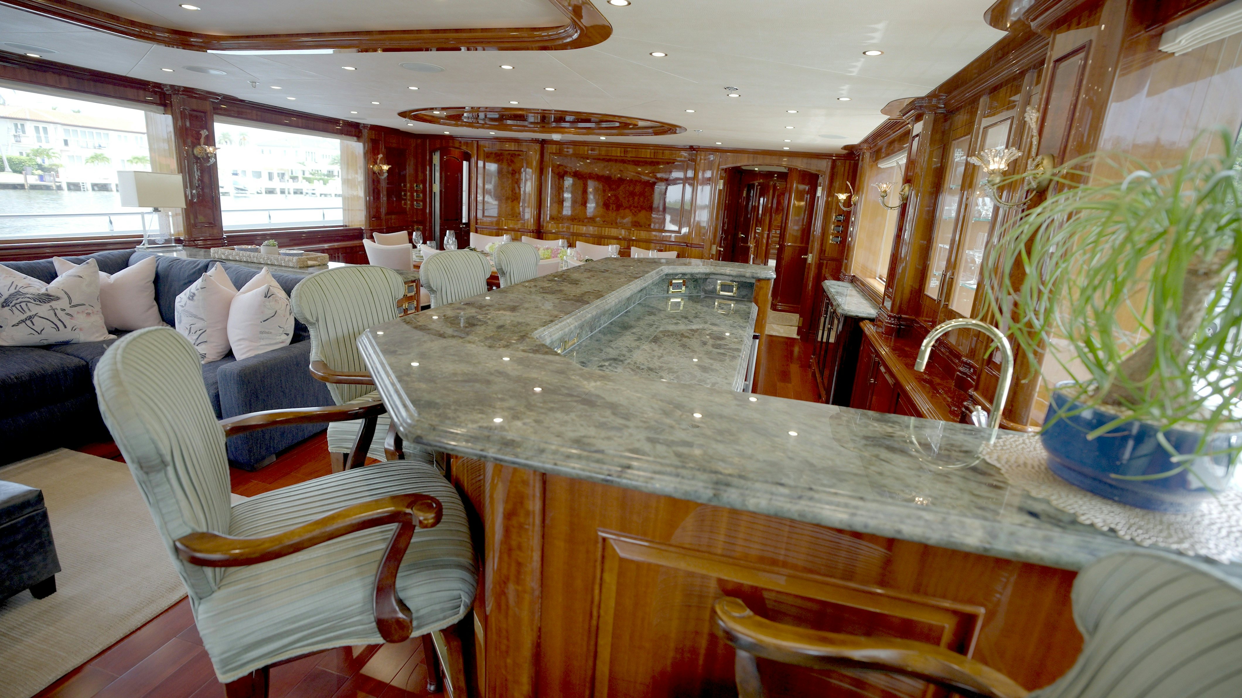 a room with a table chairs and a couch aboard HOMECOMING Yacht for Sale