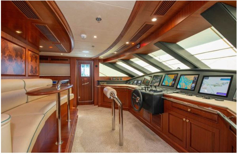 a room with a bar and a television aboard HOMECOMING Yacht for Sale