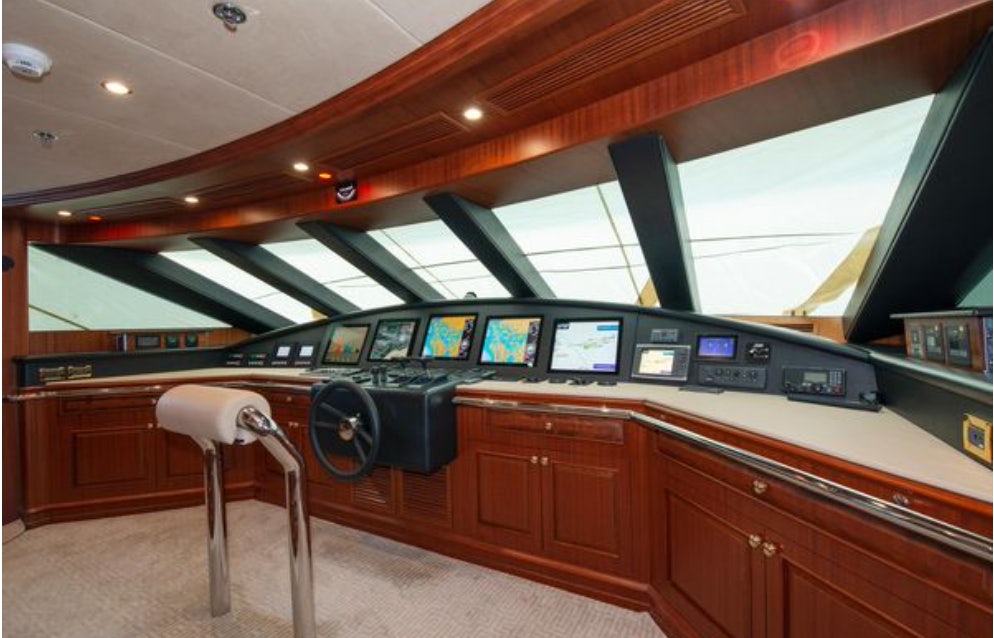 a room with a desk and chairs aboard HOMECOMING Yacht for Sale