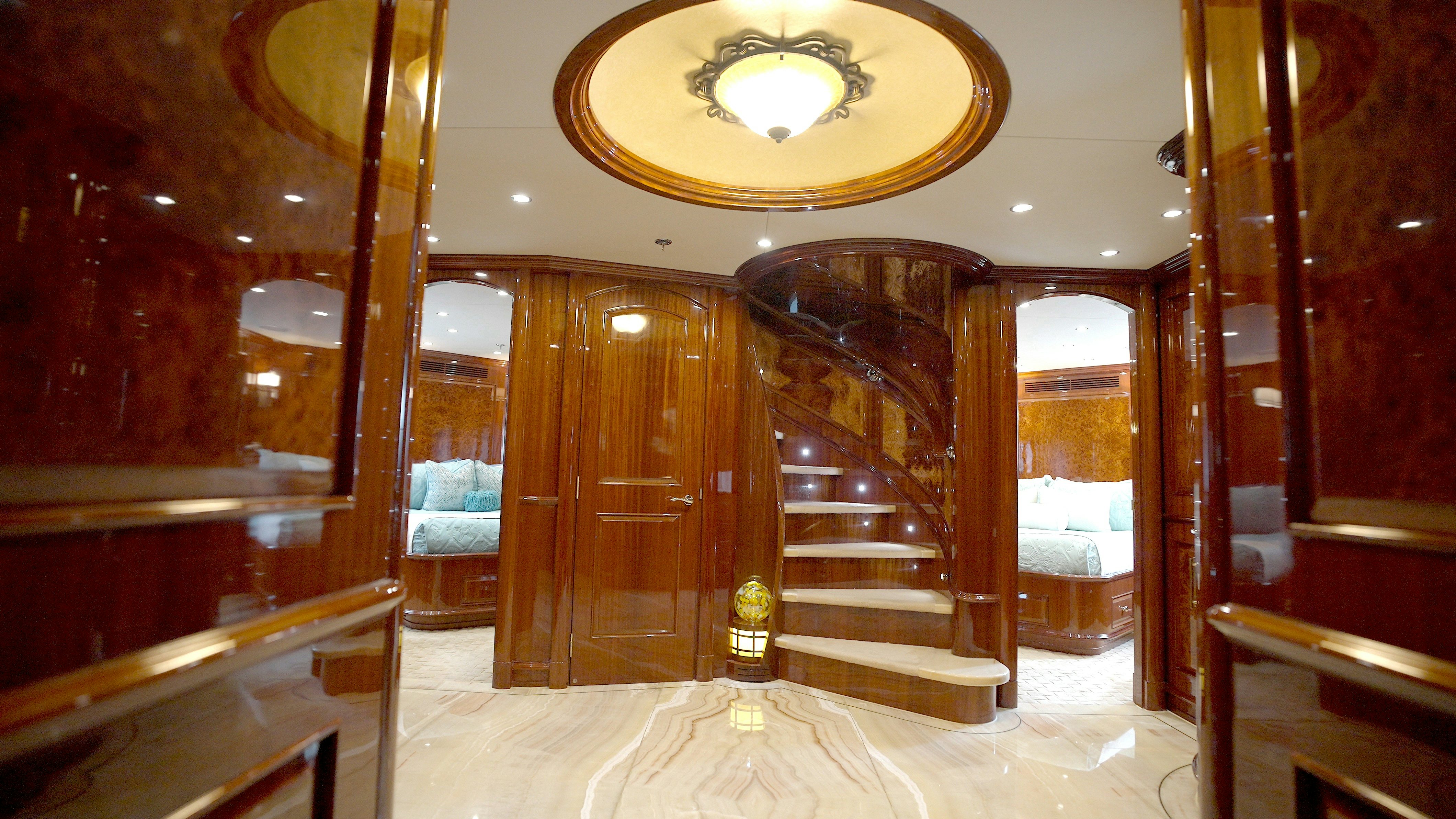 a room with a bed and a mirror aboard HOMECOMING Yacht for Sale