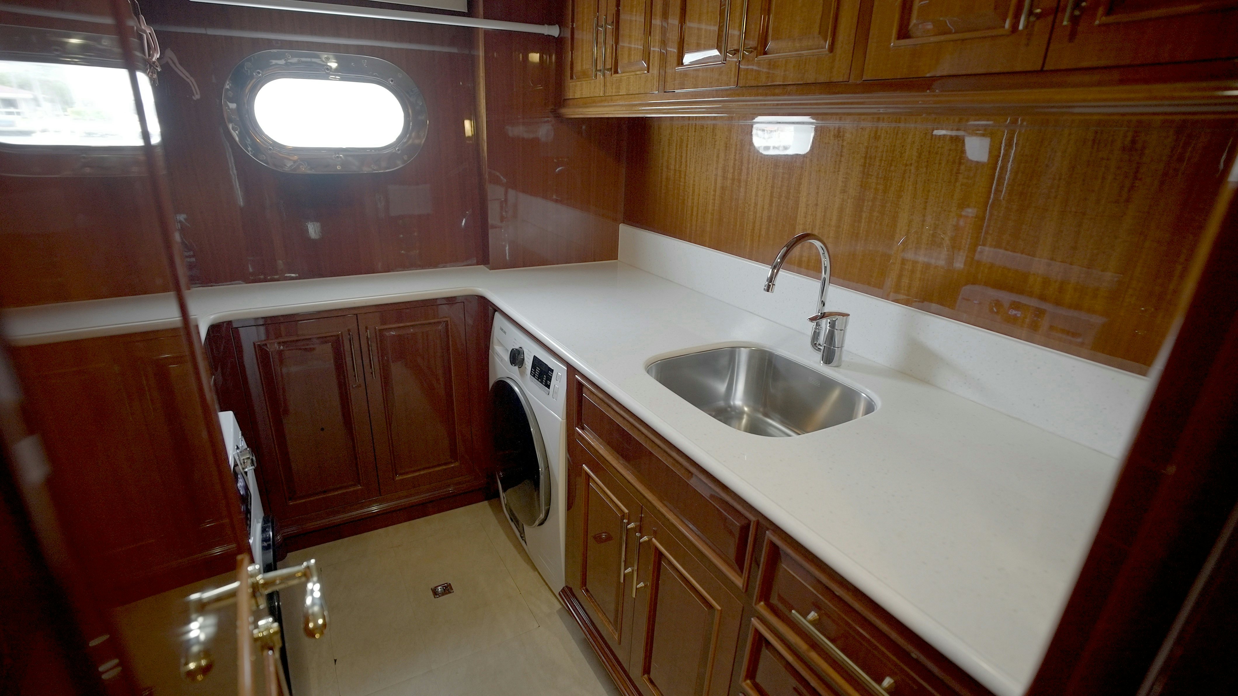 a kitchen with wooden cabinets aboard HOMECOMING Yacht for Sale