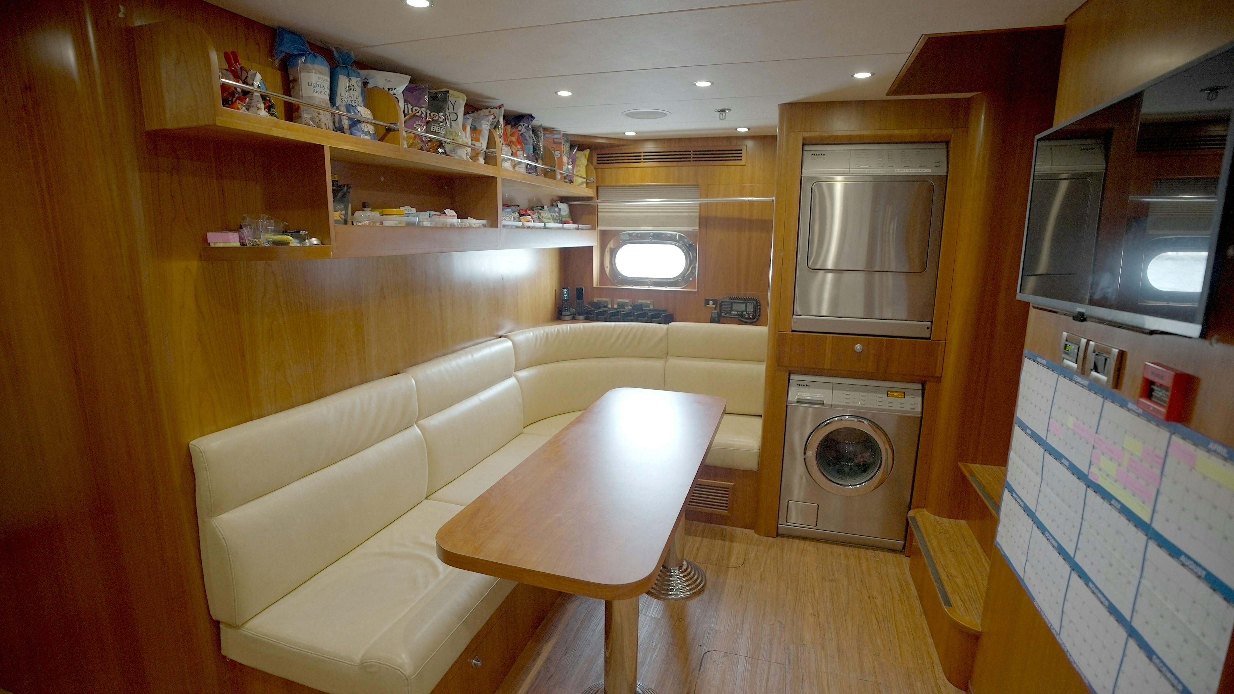 a living room with a fireplace aboard HOMECOMING Yacht for Sale
