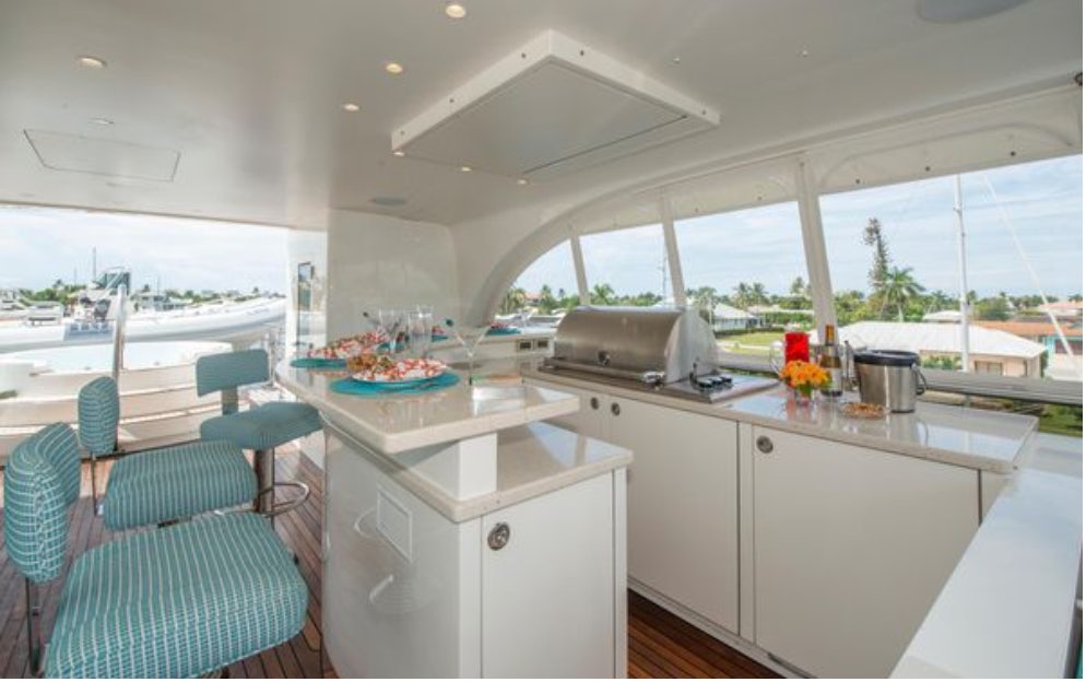 a kitchen with a table and chairs aboard HOMECOMING Yacht for Sale