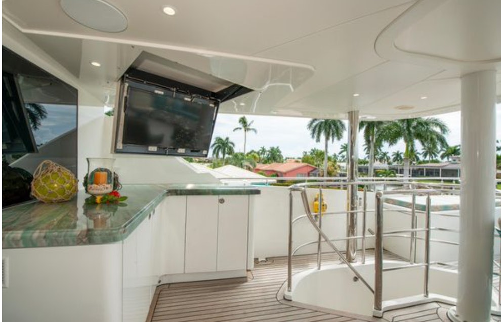 a glass wall in a room with a tv and a pool table aboard HOMECOMING Yacht for Sale