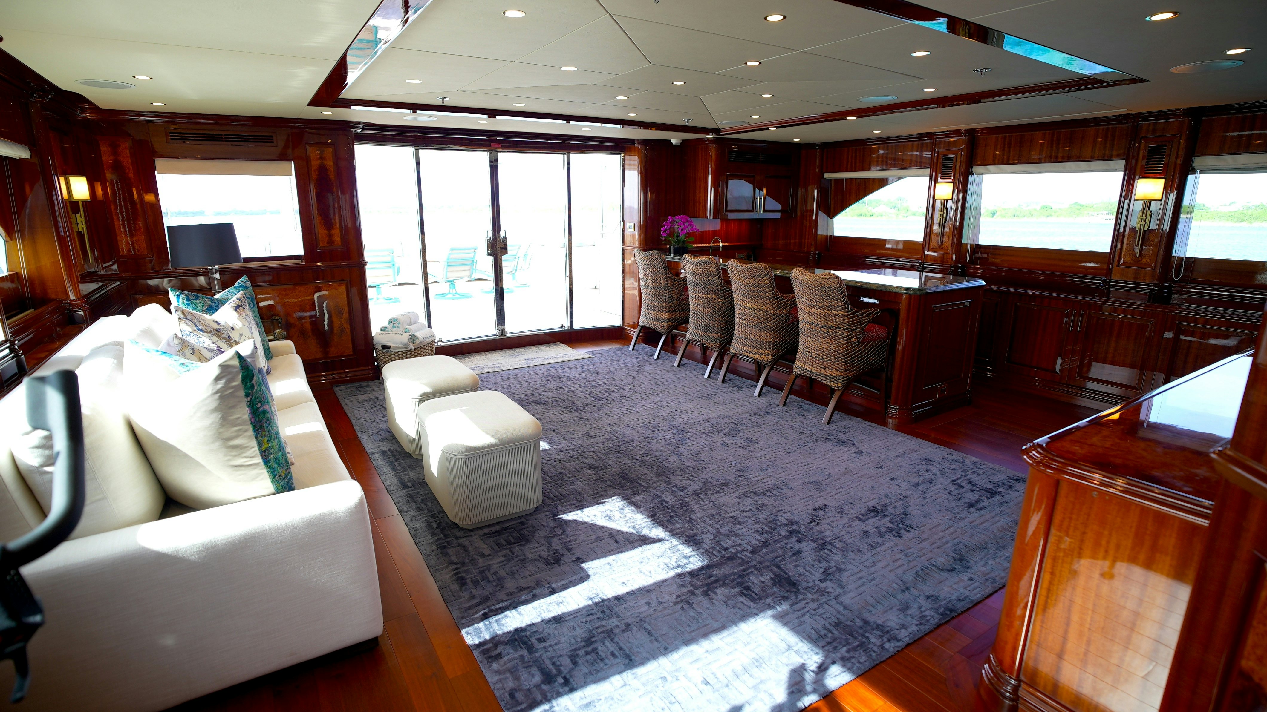 a room with a couch and a table and chairs aboard HOMECOMING Yacht for Sale