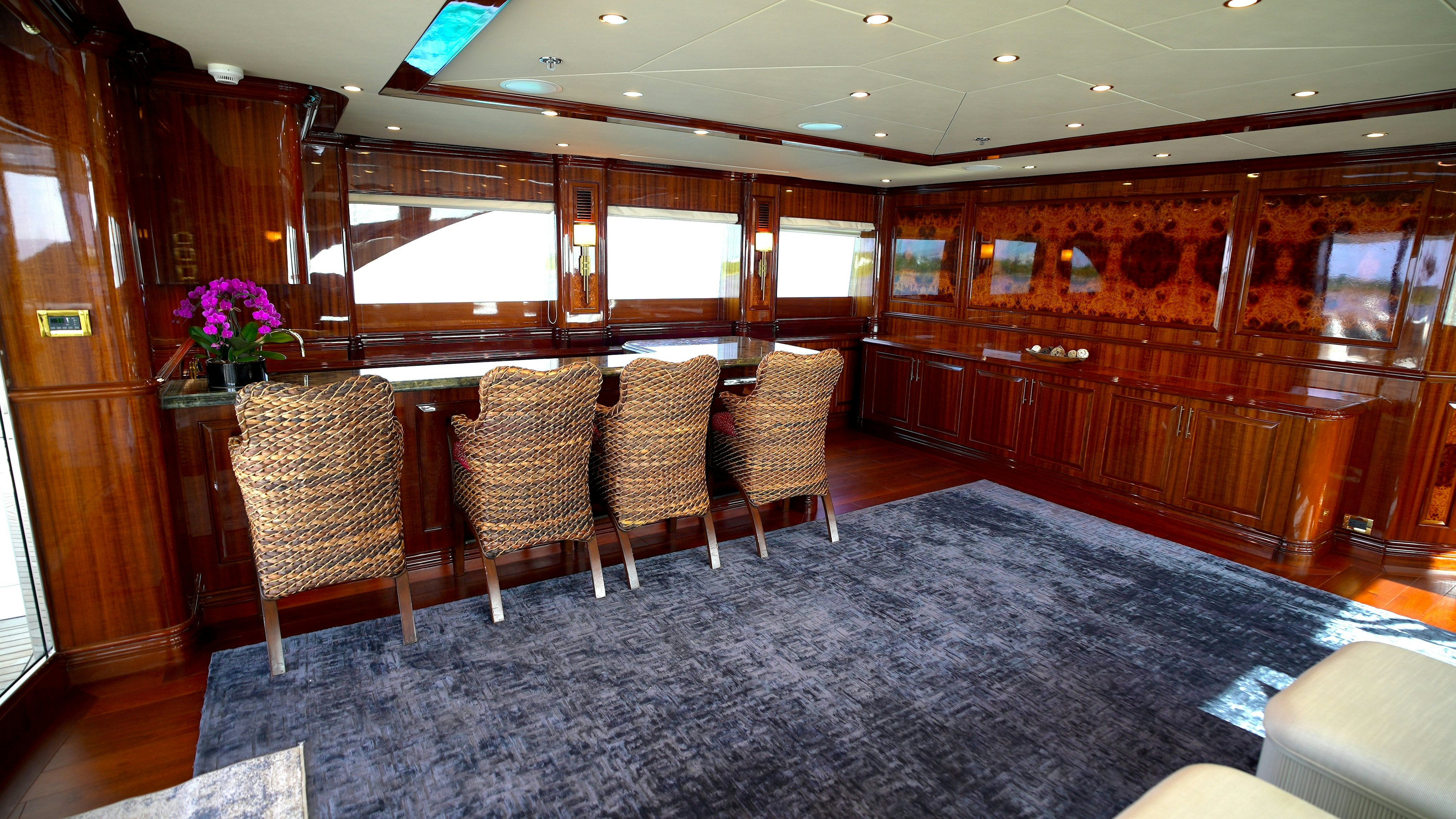 a room with chairs and a table aboard HOMECOMING Yacht for Sale